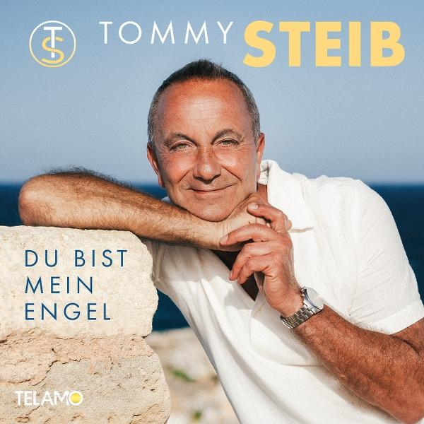 Ein Mann lehnt sich an eine Steinmauer. Text sagt: 'Du bist mein Engel'. Titel: 'Tommy Steib'.