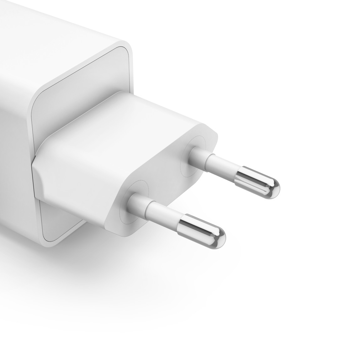 Nahaufnahme eines weißen Netzadapters mit zwei silbernen Stiften auf weißem Hintergrund.