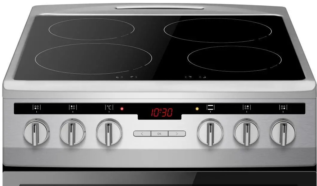 Srebrna płyta grzewcza z czterema czarnymi palnikami. Posiada cyfrowy wyświetlacz zegara i kilka pokręteł sterujących.