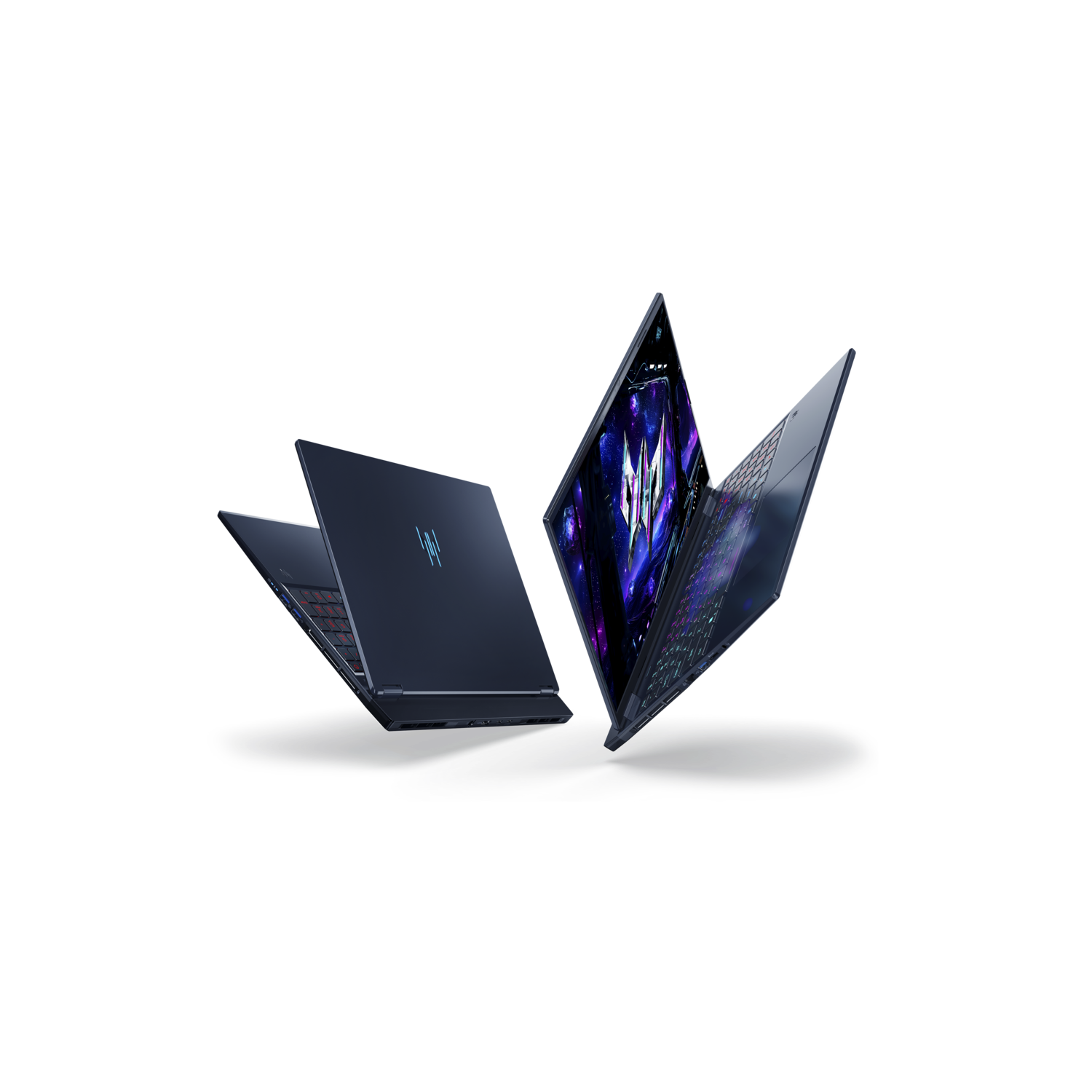 Three dark blue laptops are open, displaying screens. The background is black. The laptops are angled in different directions.