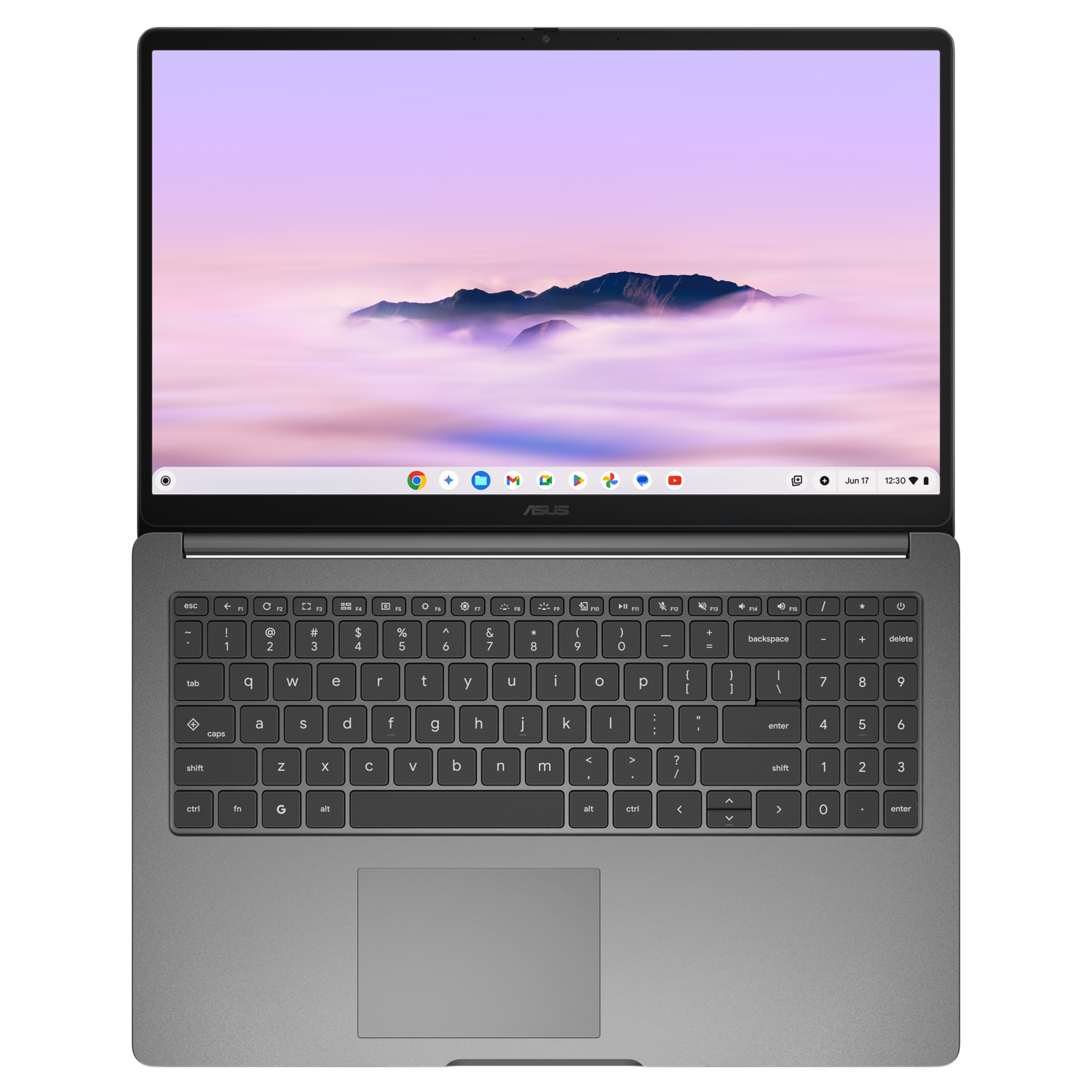 An open Asus laptop displays a mountain scene. The keyboard is visible below. The screen displays a purple sky and clouds.