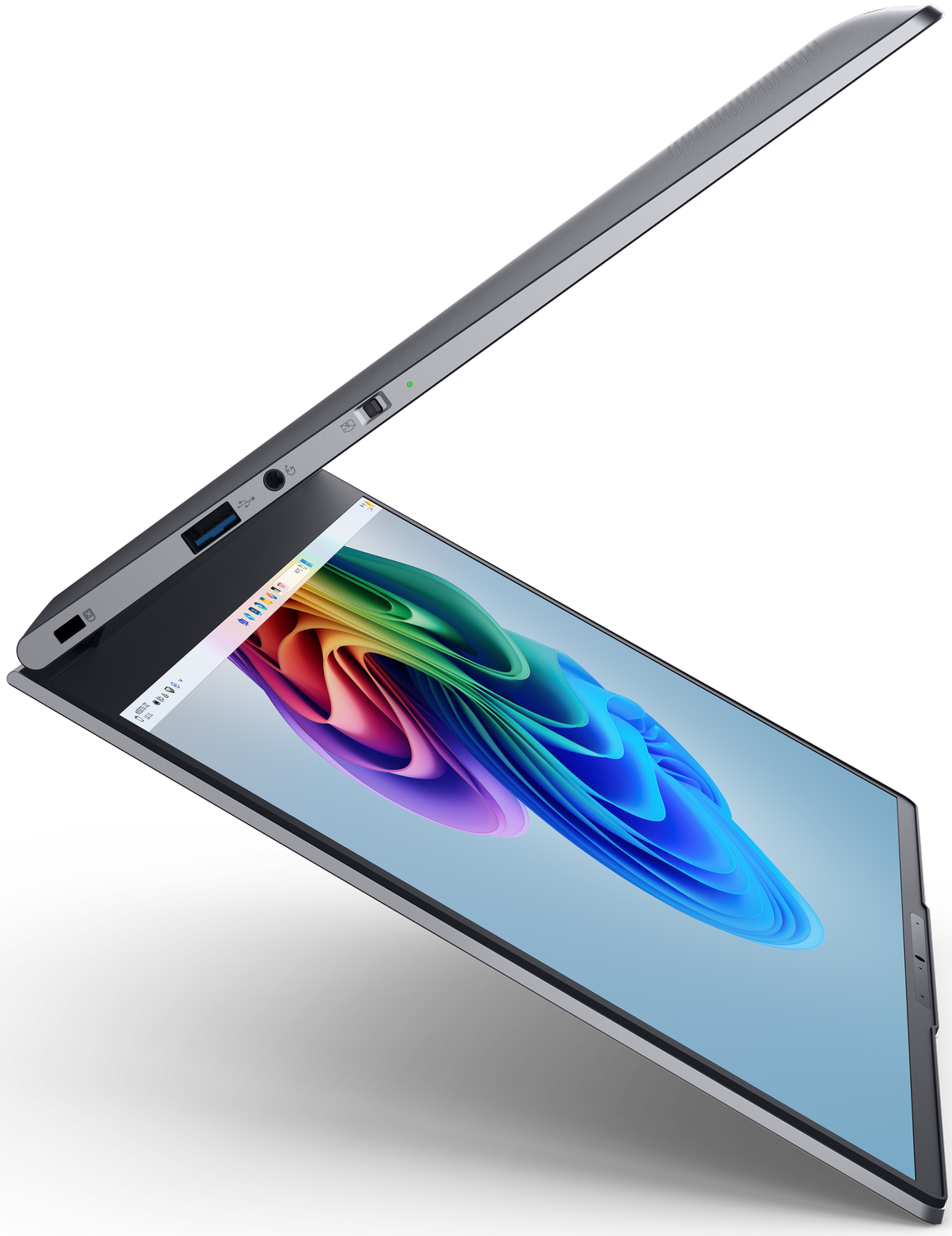 Una laptop plateada está parcialmente abierta. La pantalla muestra un diseño abstracto colorido. Los puertos y el botón de encendido son visibles.