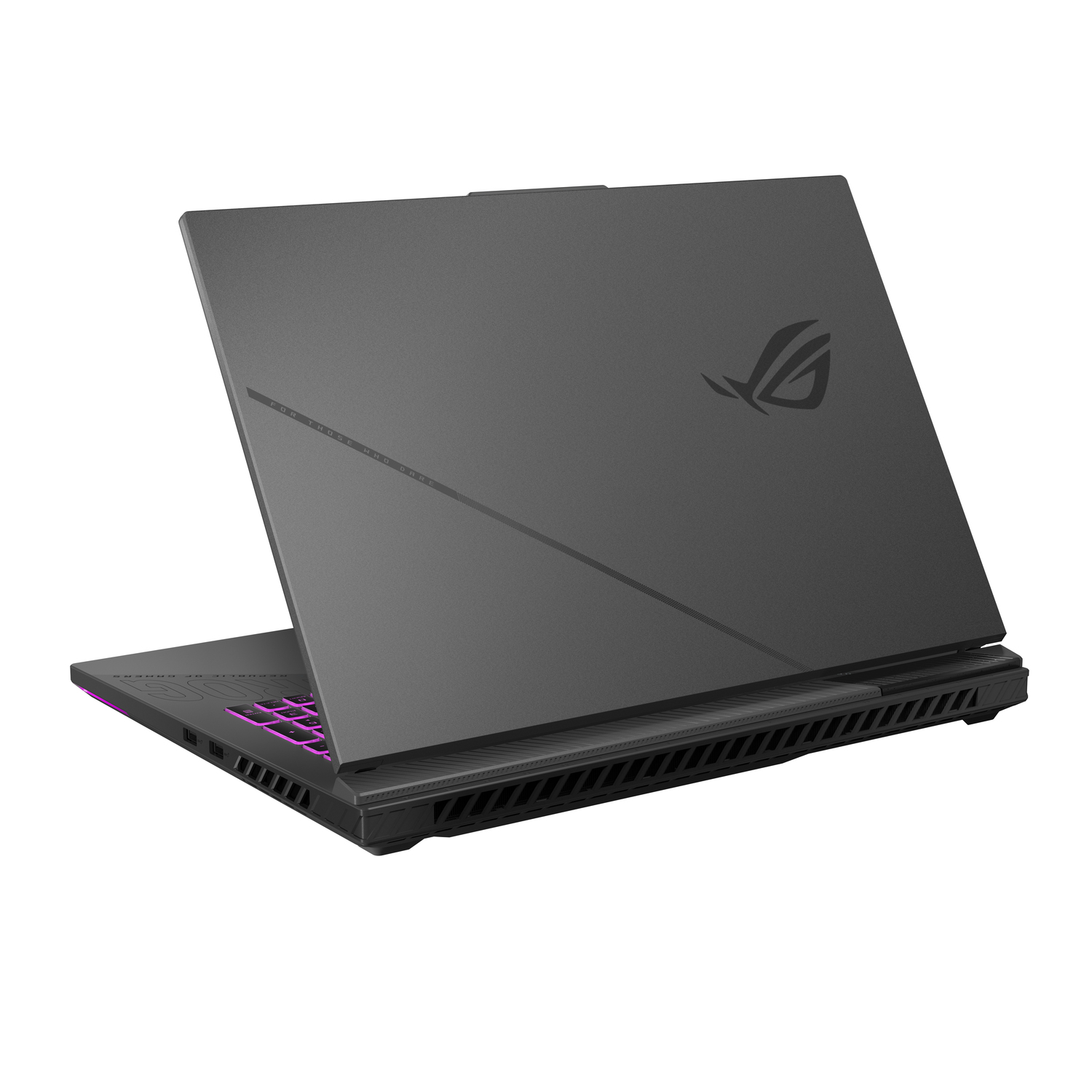 A dark gray laptop is slightly open. The keyboard is visible with pink lighting. The ROG logo is on the lid.