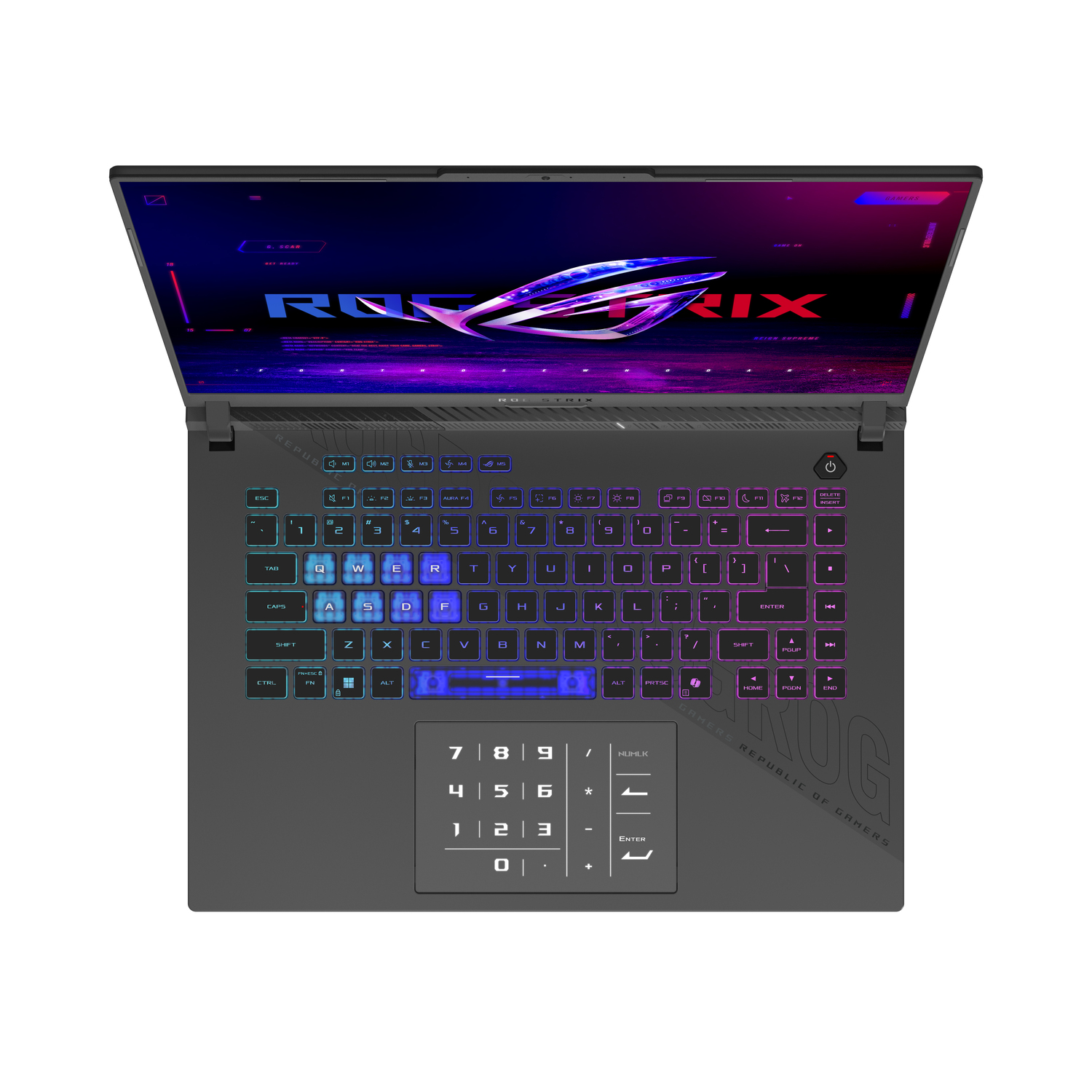 A gray ROG Strix laptop is open, showing a keyboard and screen. The screen displays ROG Strix branding and a colorful design.