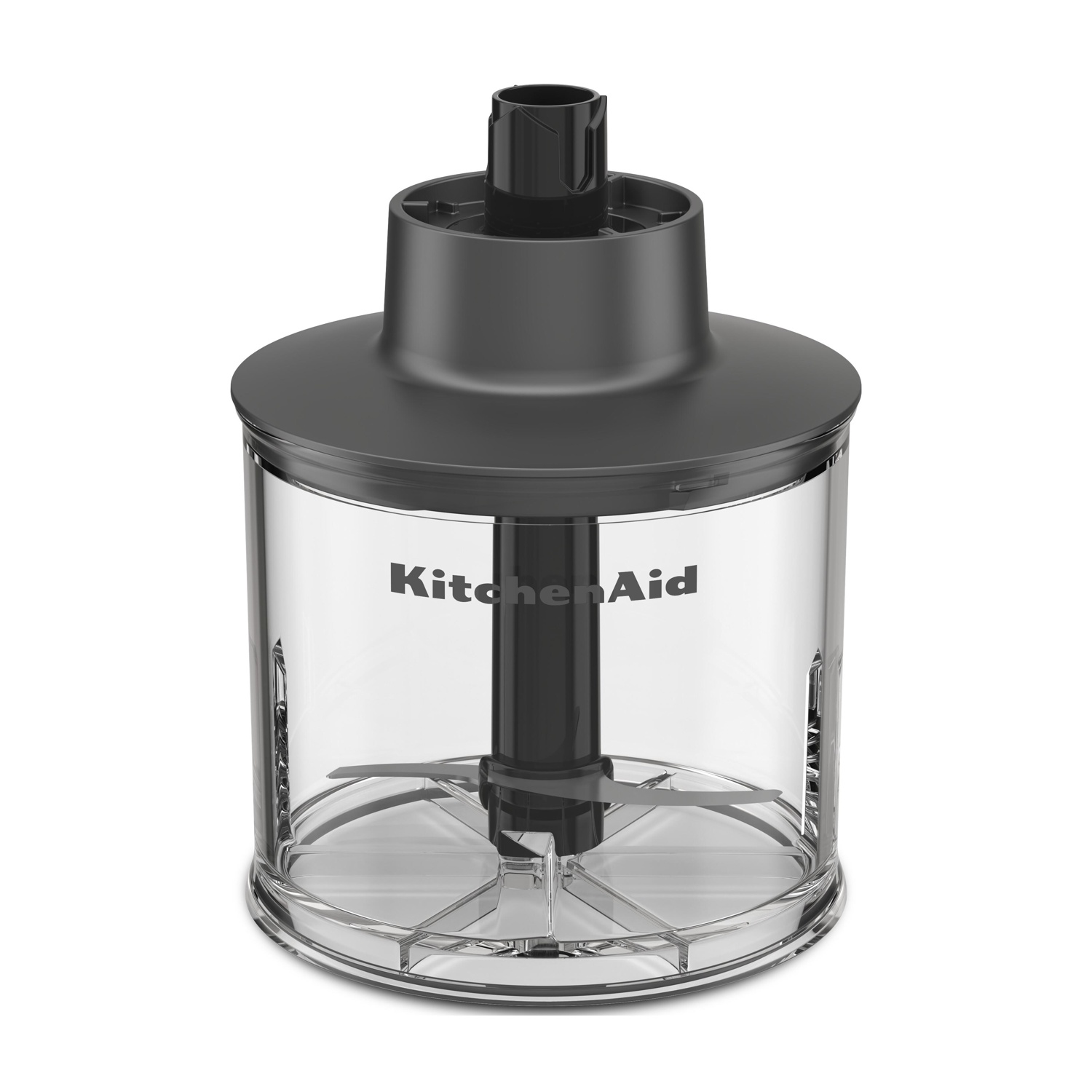 Un frullatore a immersione KitchenAid. La parte superiore è nera, il contenitore trasparente mostra il logo KitchenAid. Le lame sono visibili.