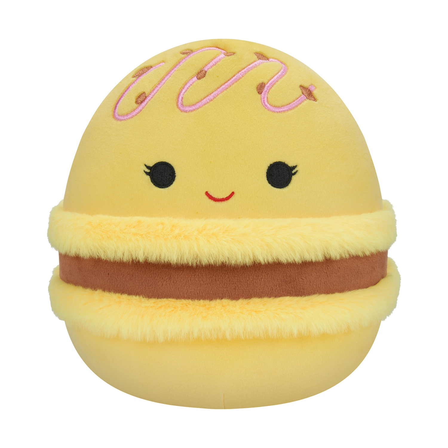 Un peluche a forma di macaron giallo. Ha una faccia sorridente, glassa rosa e un ripieno marrone.