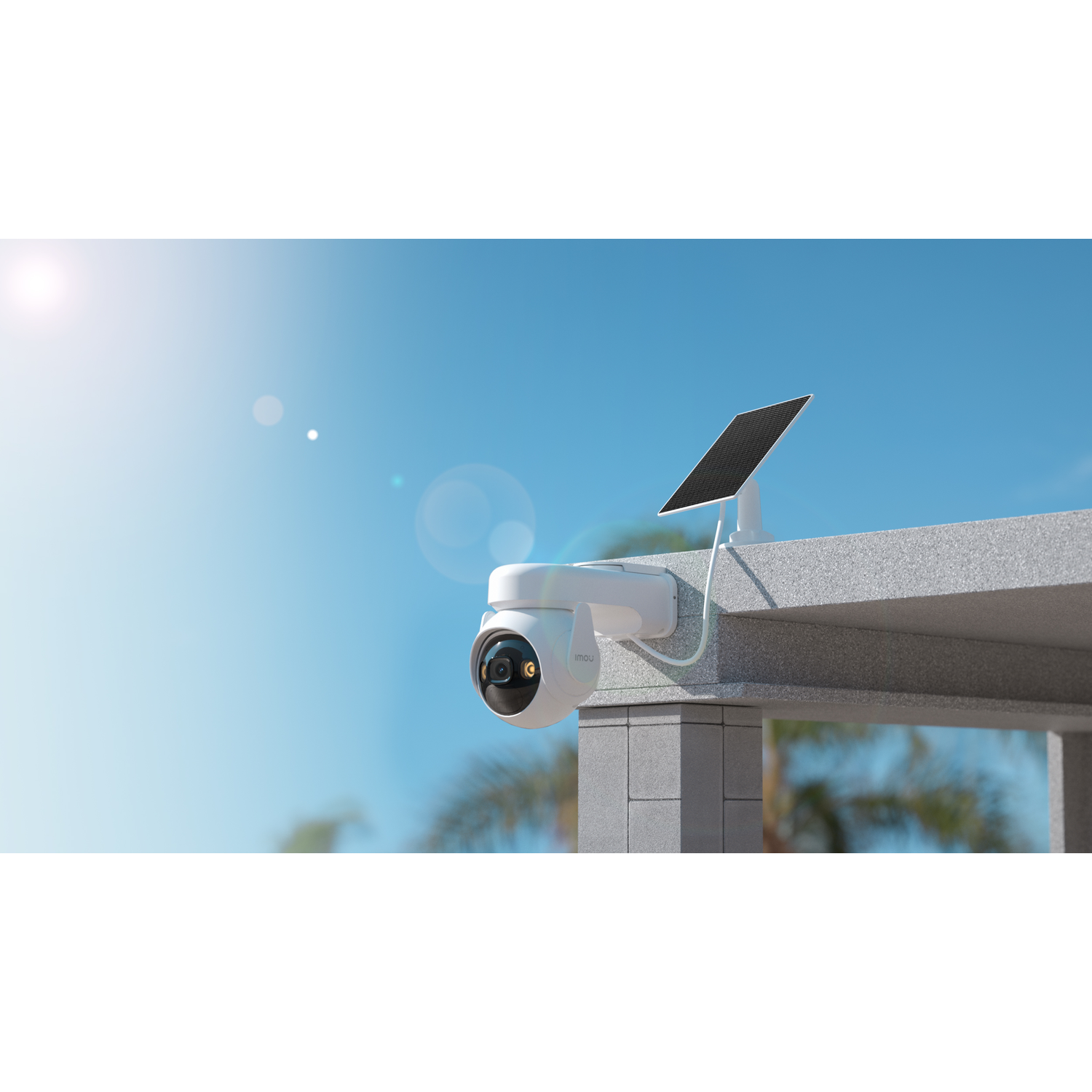 A white security camera with a solar panel is mounted on a concrete structure against a blue sky background.