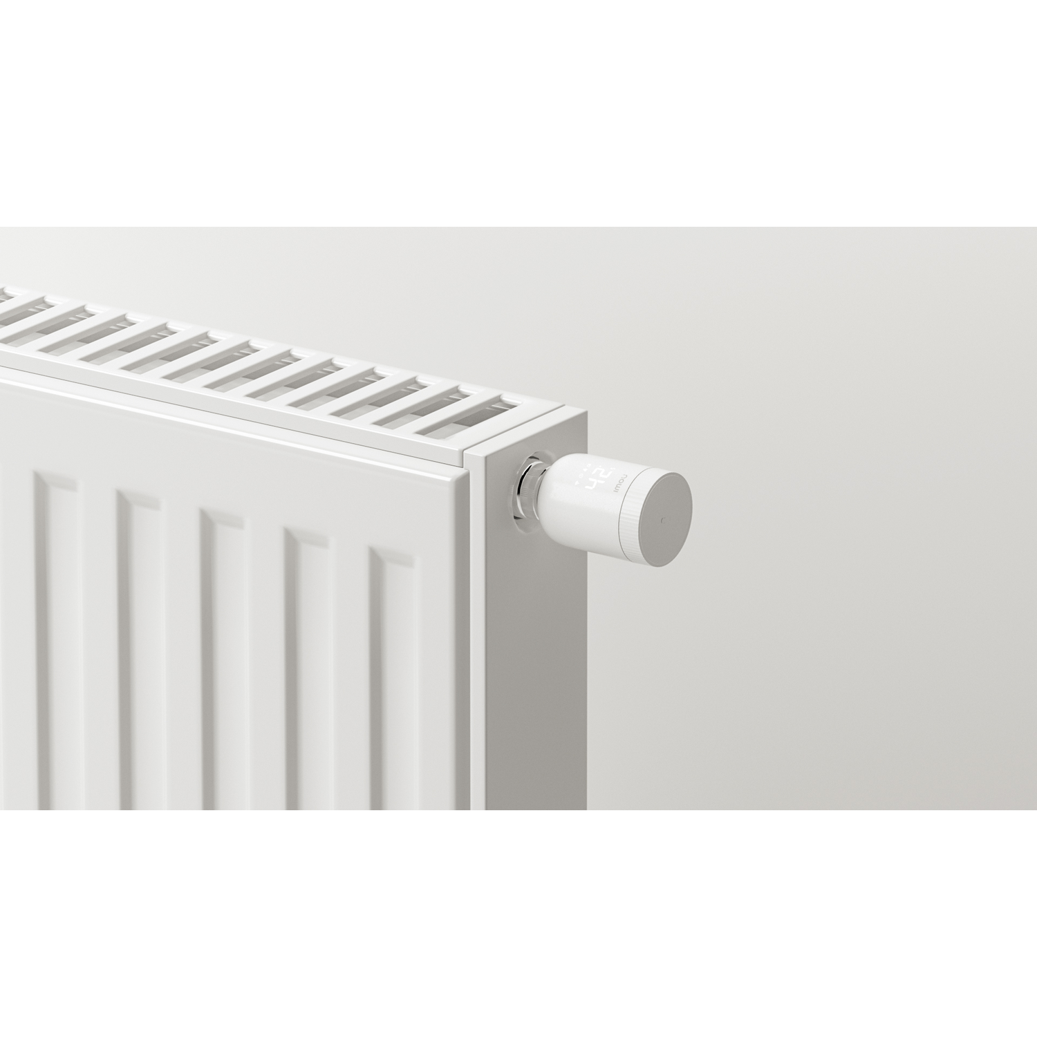 A white radiator with a smart thermostat attached. The thermostat displays a digital interface. The background is light gray.