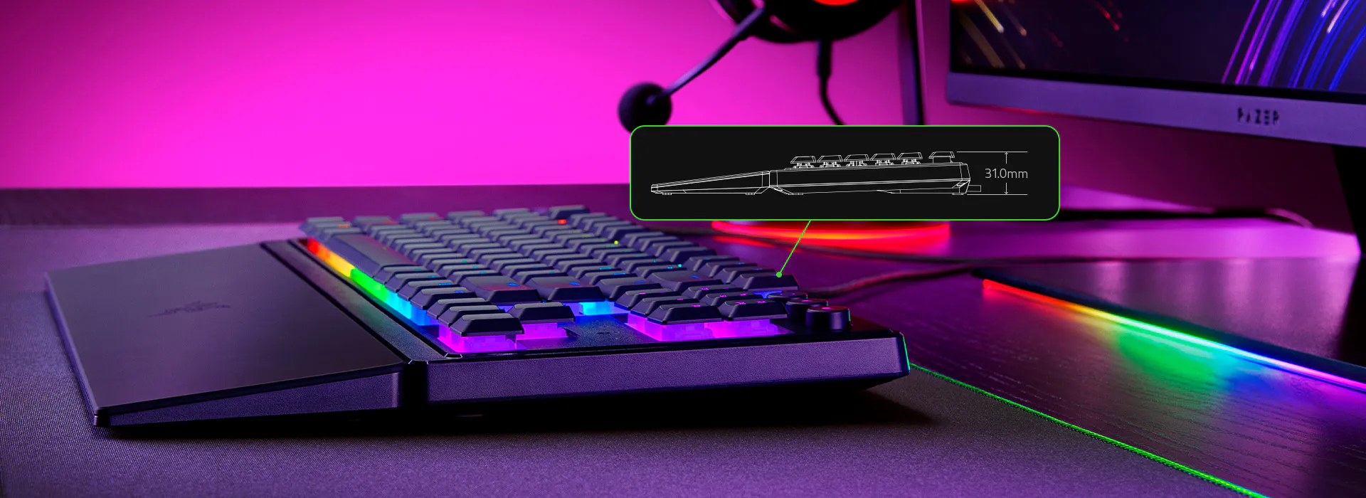 Egy fekete billentyűzet RGB világítással egy asztalon. Egy diagram a billentyűzet oldalsó profilját és méreteit mutatja.