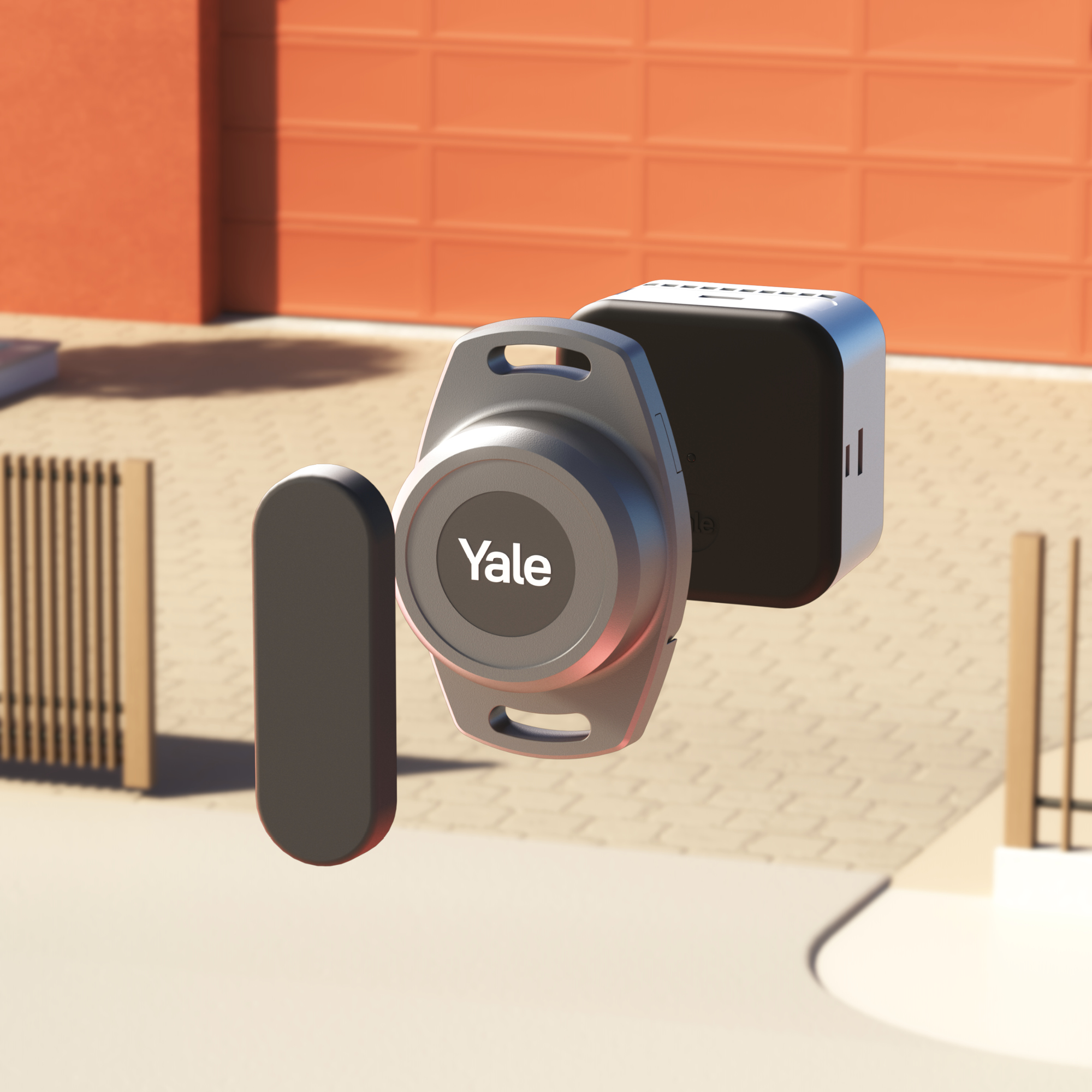 Ein Yale Smart Lock System. Es umfasst einen Schlüsselanhänger, einen Hub und einen Türsensor. Im Hintergrund ist eine Garage zu sehen.
