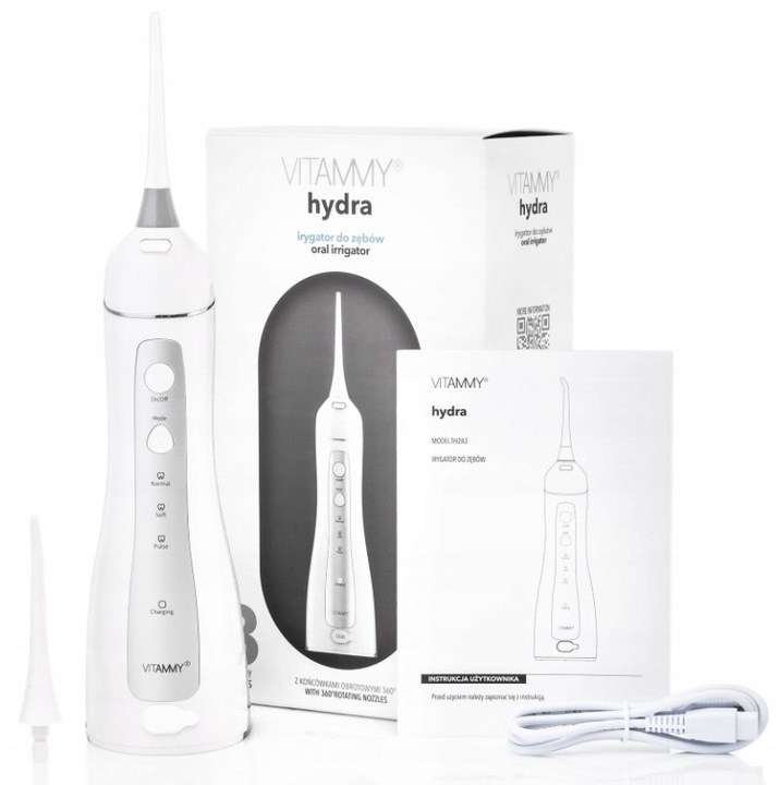 Biały irygator do jamy ustnej, pudełko i instrukcja z napisem 'VITAMMY hydra'. Obecne są również akcesoria i kabel ładujący.