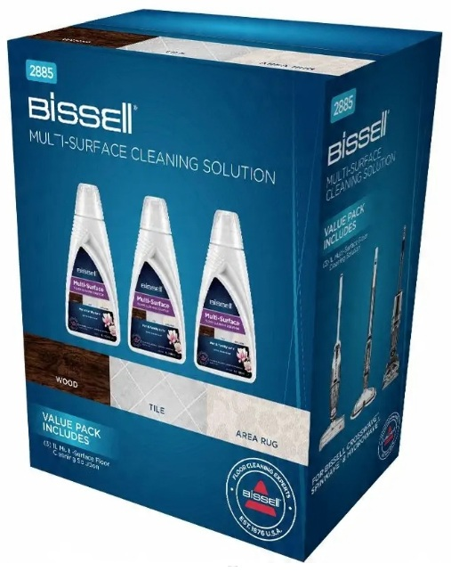 Pudełko z roztworem czyszczącym Bissell do wielu powierzchni z trzema butelkami, próbkami drewna, płytek, dywanów i narzędzi.