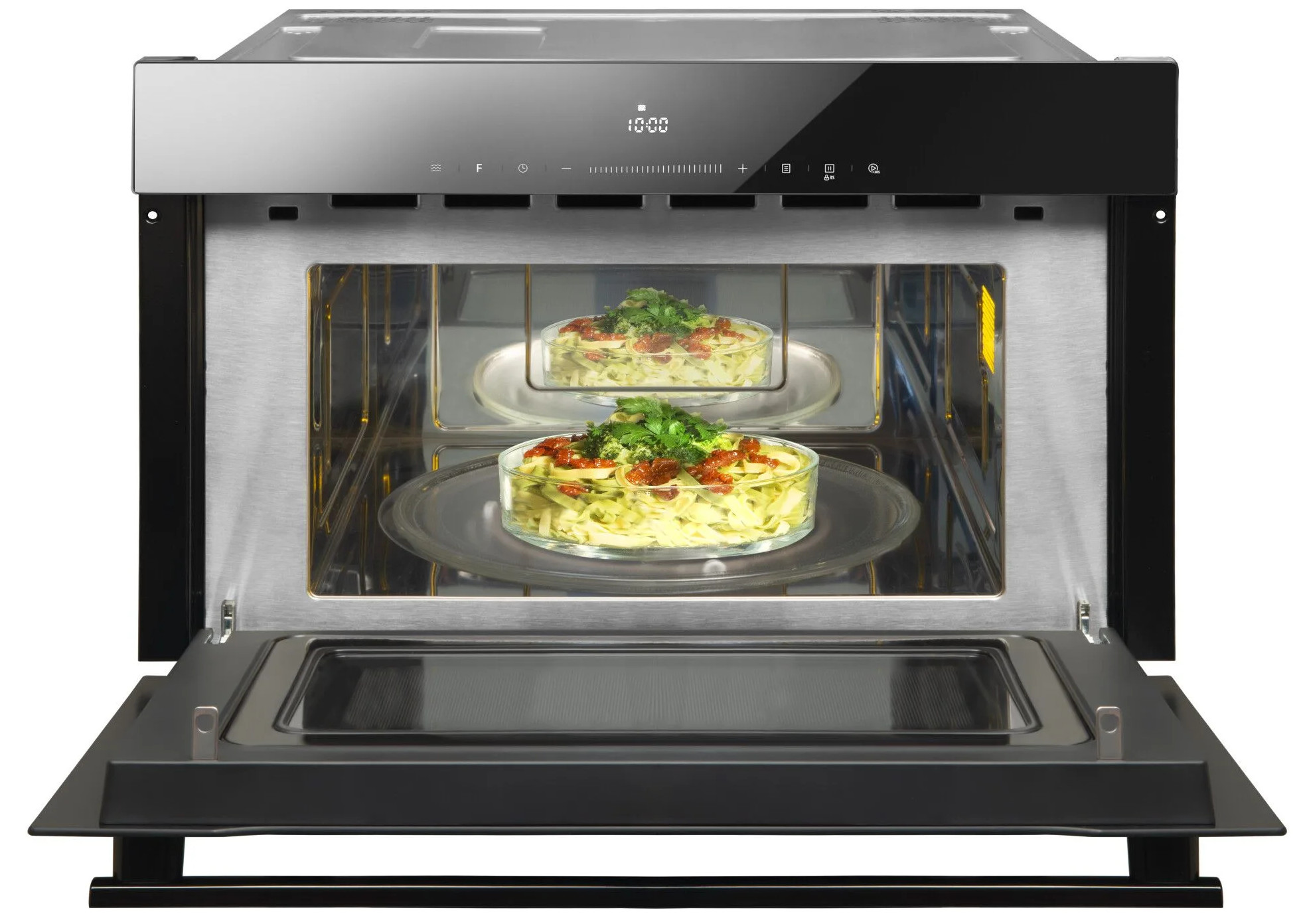 Otwarty piekarnik mikrofalowy z dwoma szklanymi naczyniami z makaronem w środku. Piekarnik jest ze stali nierdzewnej i czarny.