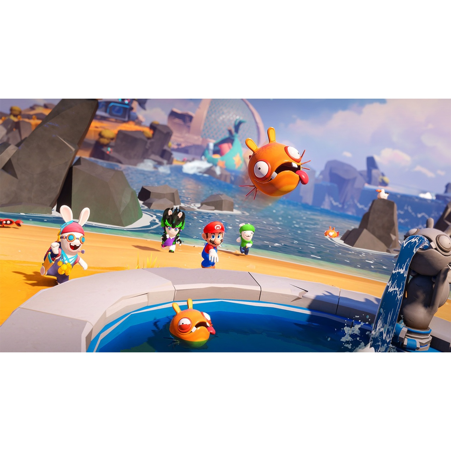 Personaggi di Mario e Rabbids su una spiaggia con creature arancioni. Lo sfondo presenta acqua, rocce e una struttura.