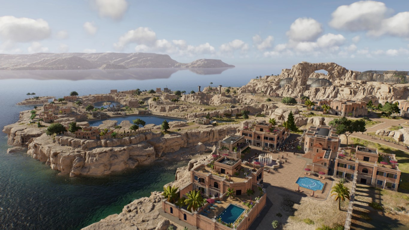 Nadbrzeżne miasto z budynkami, basenami i drzewami na skalistym krajobrazie. W tle góry i woda, pod błękitnym niebem.