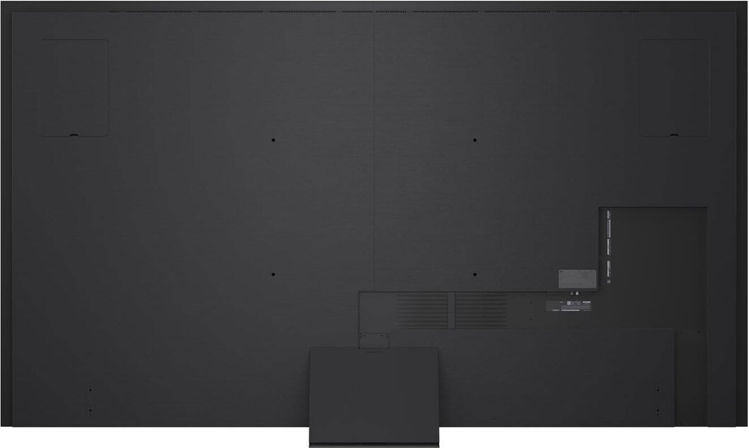 Dos d'un grand écran noir avec panneaux encastrés, ports et base rectangulaire en bas.