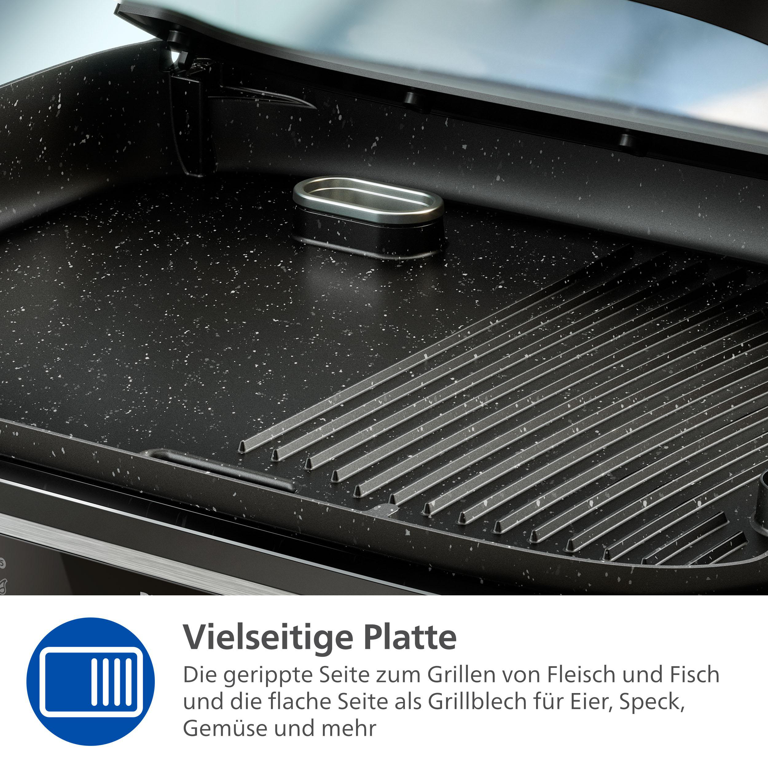 Nahaufnahme einer Grillfläche mit teilweise geöffnetem Deckel. Die Oberfläche ist schwarz mit weißen Sprenkeln und Grillmarkierungen.