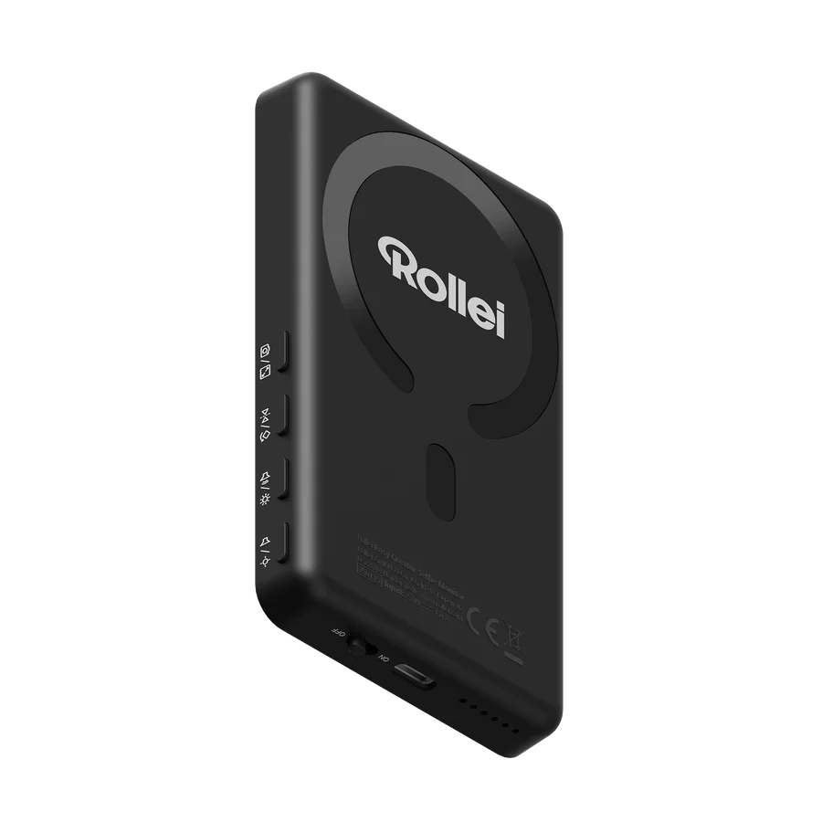 Ein schwarzes Rollei-Gerät mit Knöpfen und einem kreisförmigen Design. Das Logo 'Rollei' ist sichtbar. Ein Netzschalter und eine Reihe von Punkten befinden sich unten.