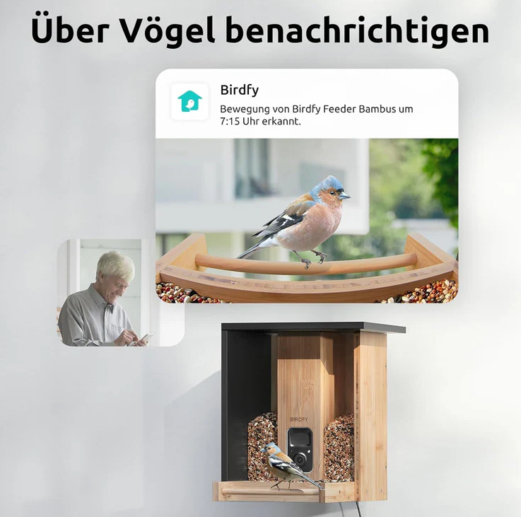Ein Vogelfutterautomat mit Kamera. Ein Vogel sitzt darauf. Eine Benachrichtigung erwähnt Vogelbewegung um 7:15 Uhr. Ein Mann benutzt ein Telefon.