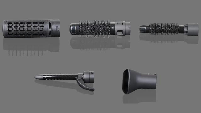 Mehrere schwarze Aufsätze für Haarstyling-Tools liegen auf einer grauen Oberfläche. Enthält Aufsätze zum Locken, Bürsten und Trocknen.