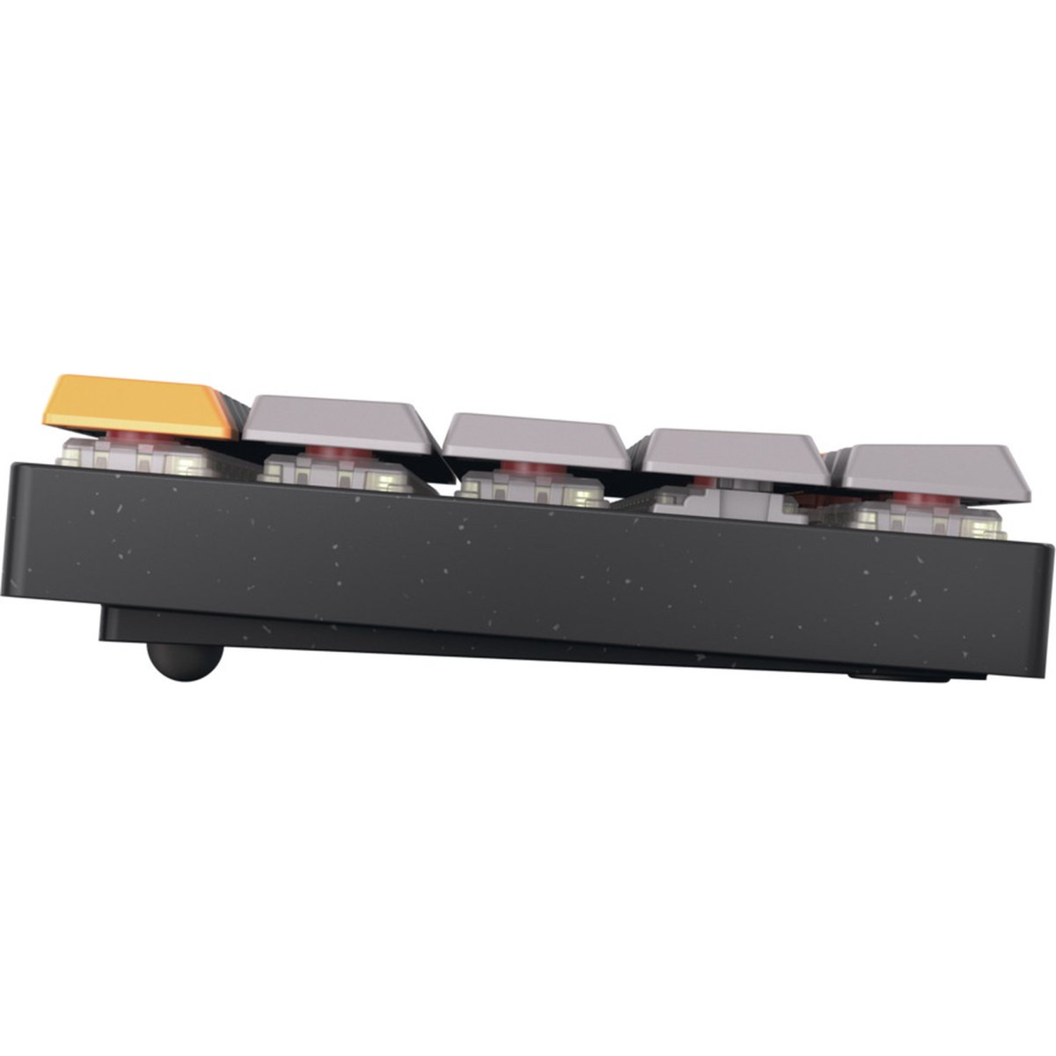 Side view of a mechanical keyboard. It features gray keys and one orange key. The keyboard base is black and speckled.
