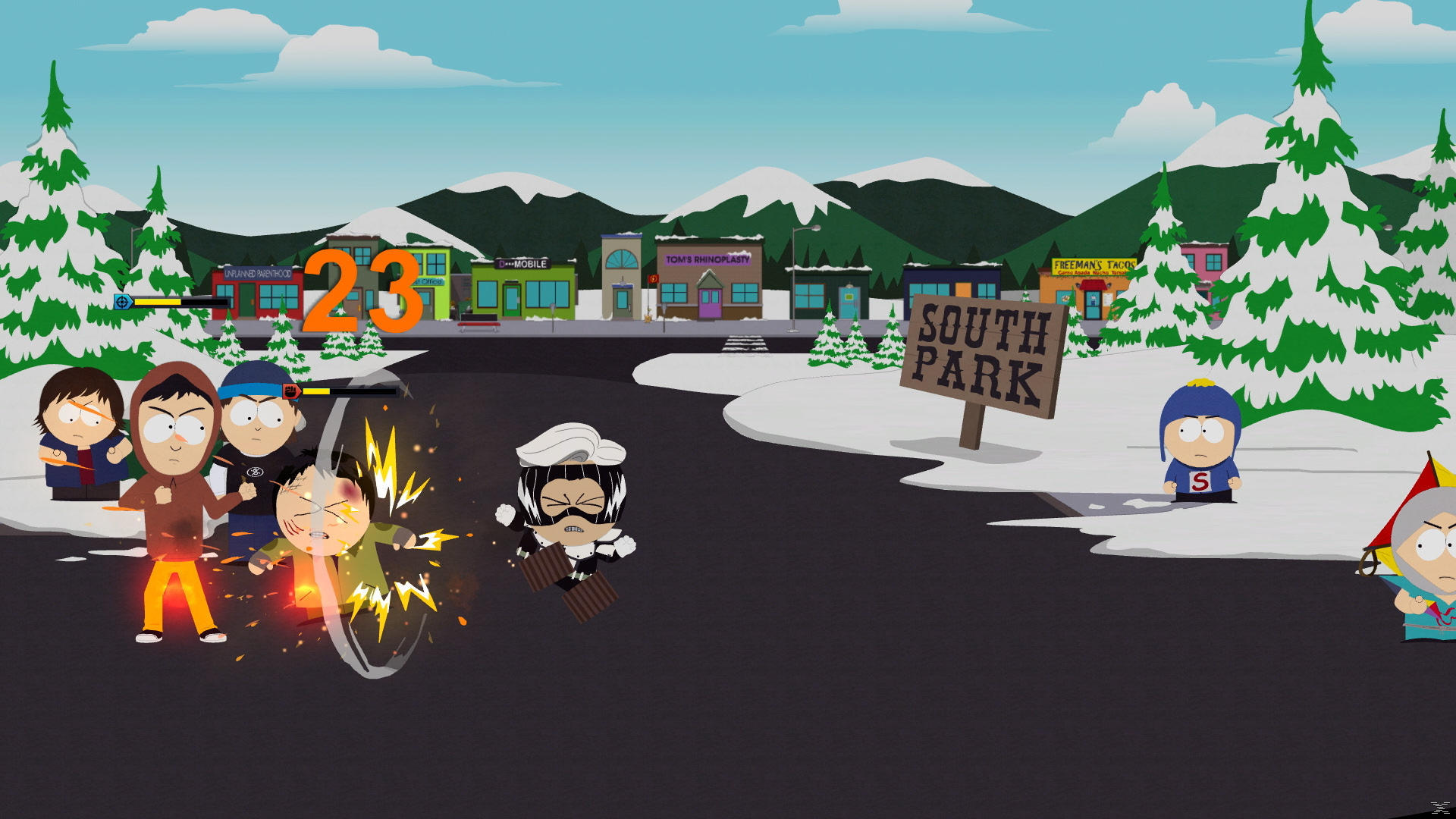 South Park-Szene. Charaktere kämpfen, Gebäude im Hintergrund, Schild mit South Park. Berge und Schnee im Hintergrund.
