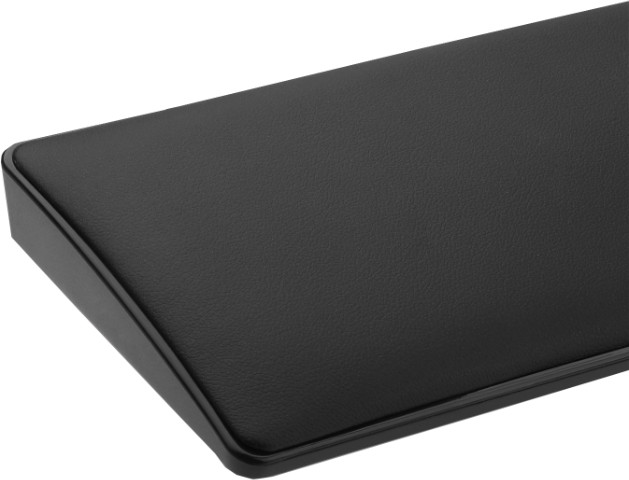 Zbliżenie czarnego, teksturowanego obiektu z zaokrąglonymi krawędziami. Powierzchnia wydaje się być skórą lub podobnym materiałem.