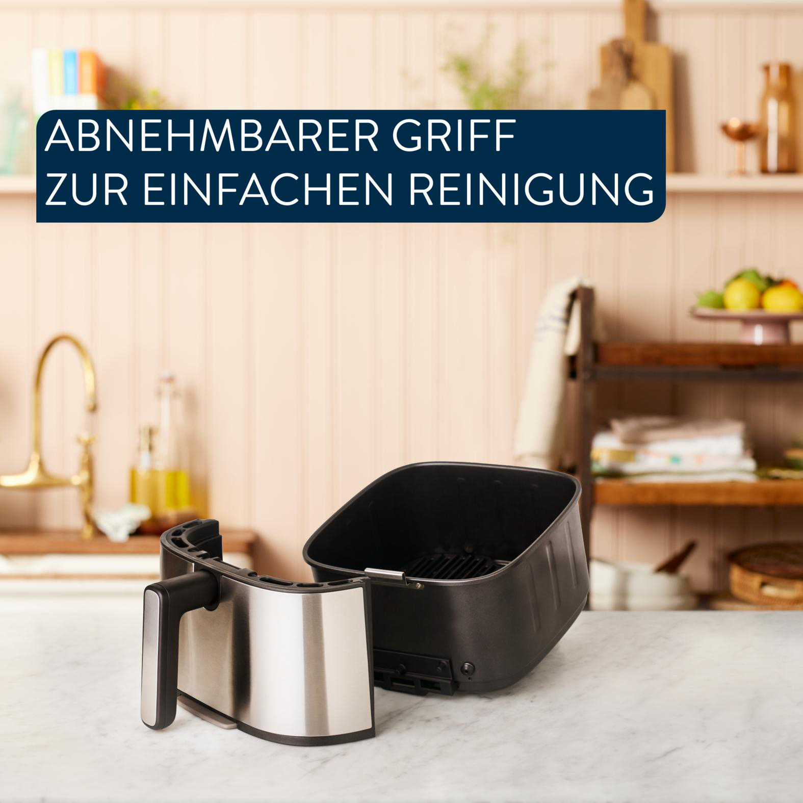 Eine Heißluftfritteuse mit abnehmbarem Griff. Text: abnehmbarer Griff zur einfachen Reinigung.