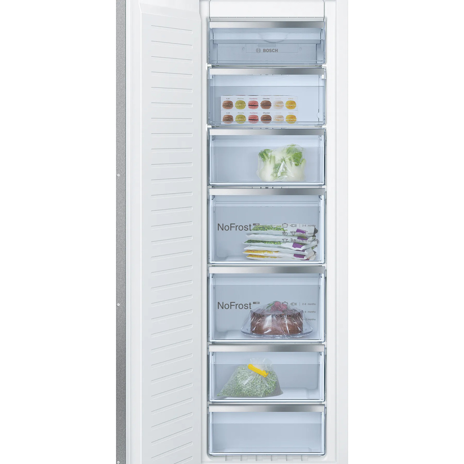 A white freezer with open door reveals various drawers. Inside, there are vegetables, a cake, and packaged frozen goods.