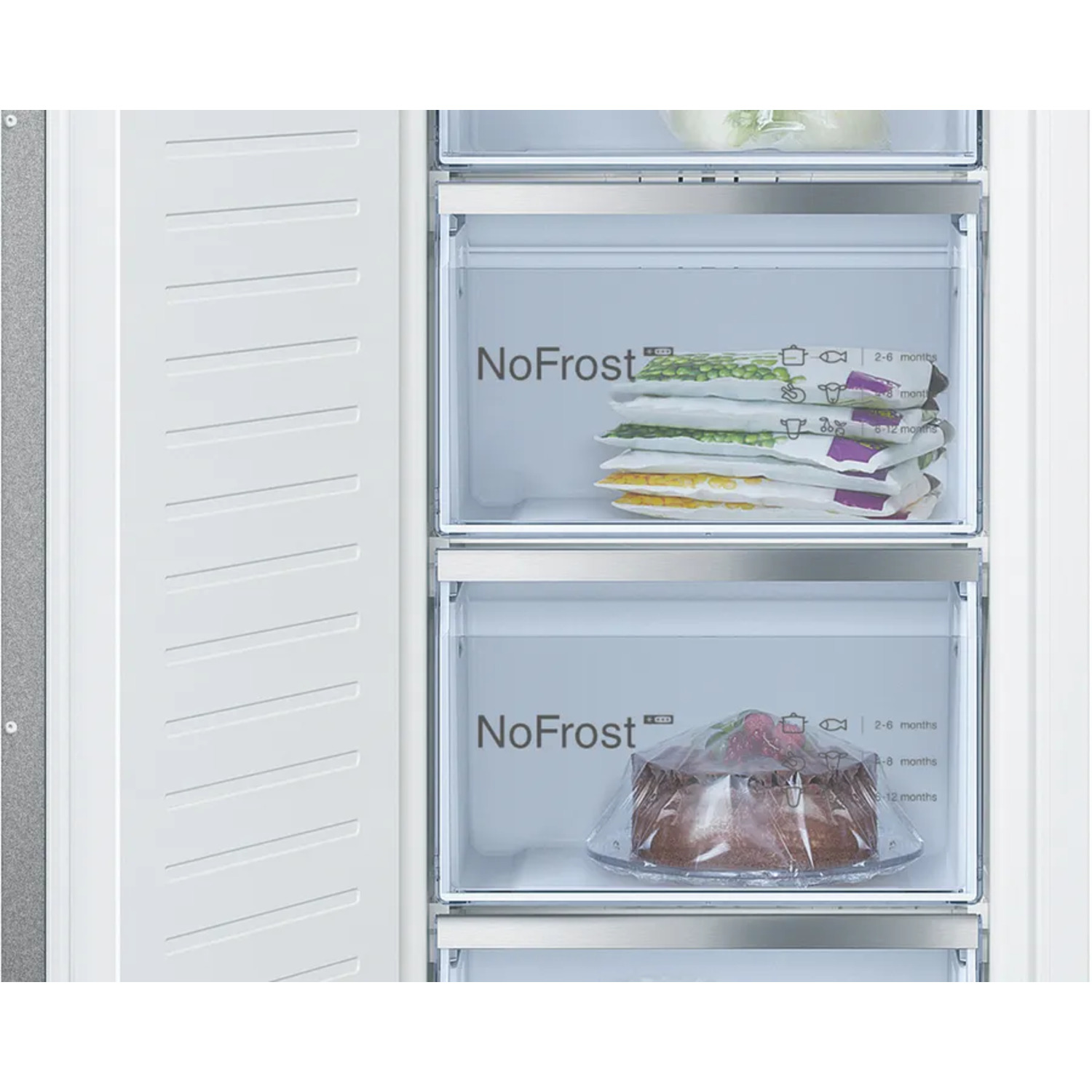 A freezer with drawers containing frozen peas, corn, and a cake. The freezer is white with a NoFrost logo.