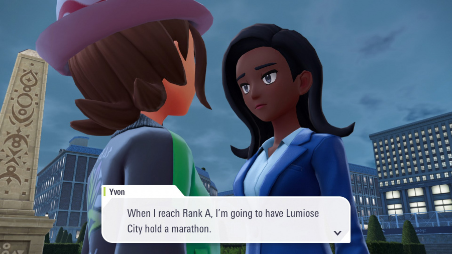 Dwóch postaci z anime rozmawia. Jeden ma na sobie kapelusz. Dymek z tekstem mówi: „Kiedy osiągnę rangę A, zorganizuję w Lumiose City maraton”.