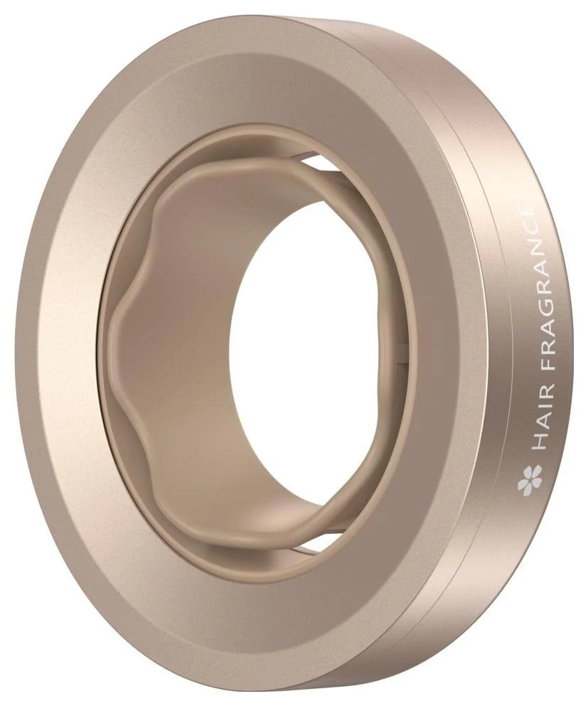 Un difusor de fragancia para el cabello beige. Tiene forma circular con un anillo interior ondulado. El texto 'FRAGANCIA PARA EL CABELLO' es visible.