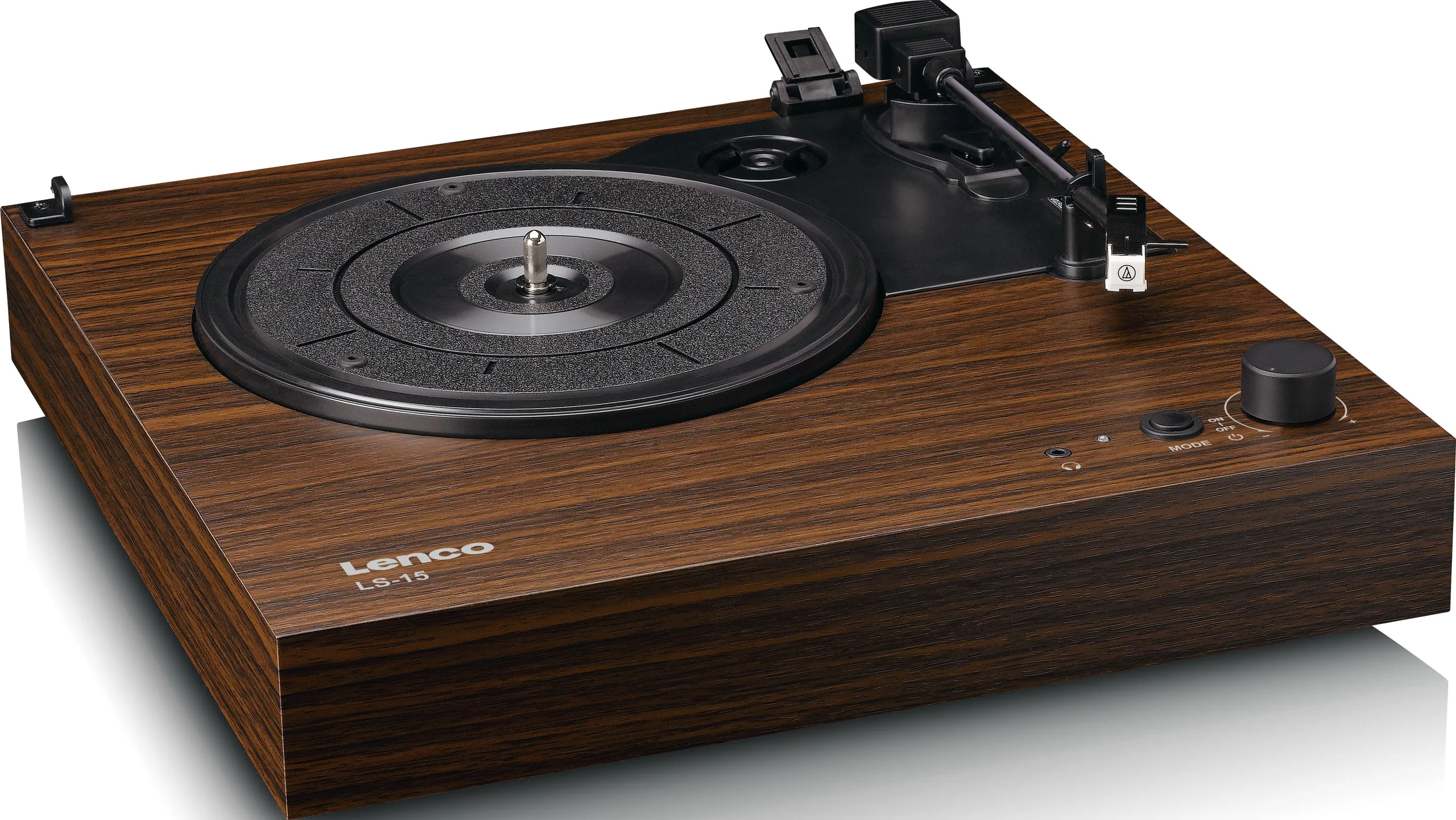 Une platine vinyle Lenco LS-15 en bois. Elle comporte un plateau noir, un bras de lecture et des boutons. L'appareil est posé sur une surface blanche.