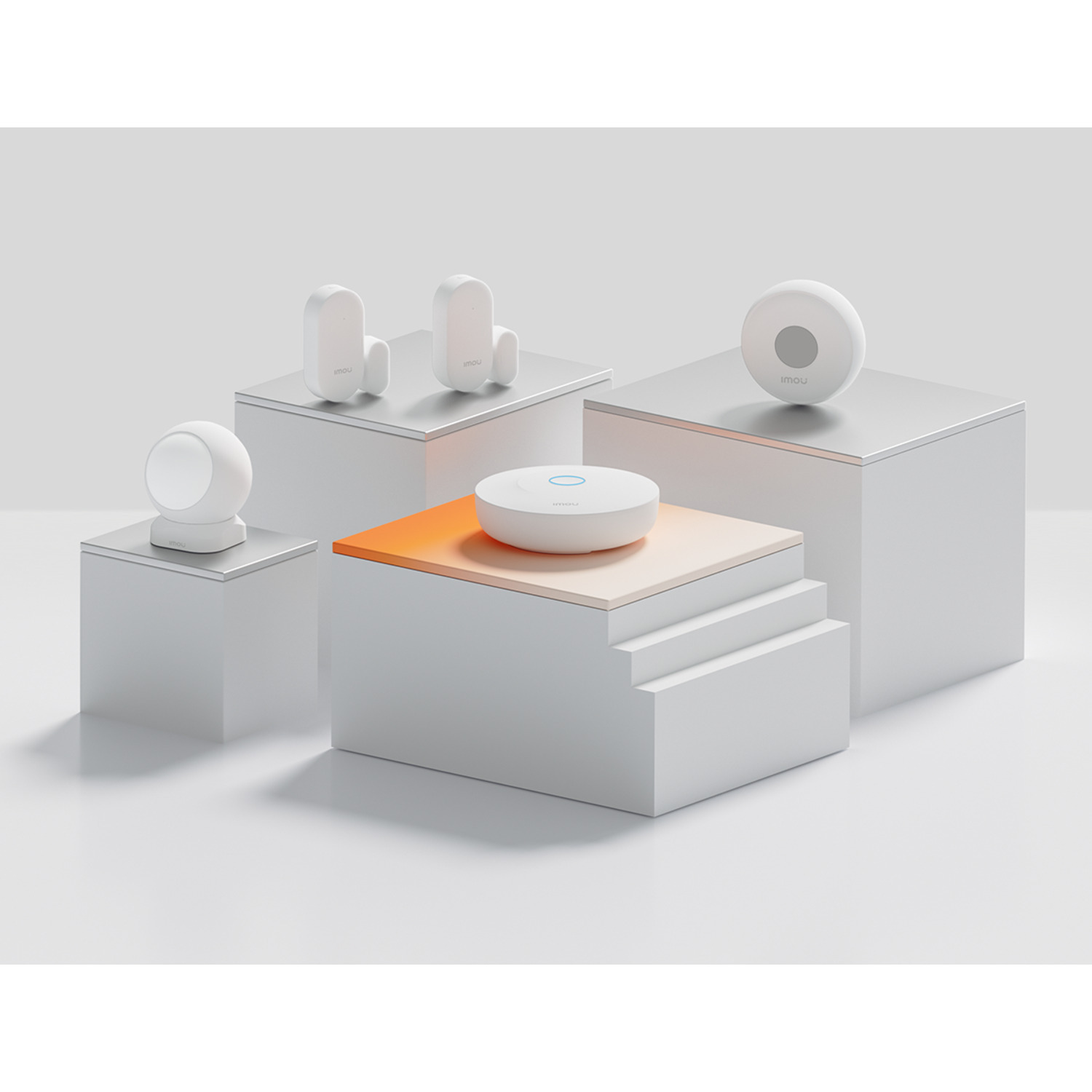 White security devices on white pedestals. One round camera, two door sensors, one sensor, and a hub with a blue ring.