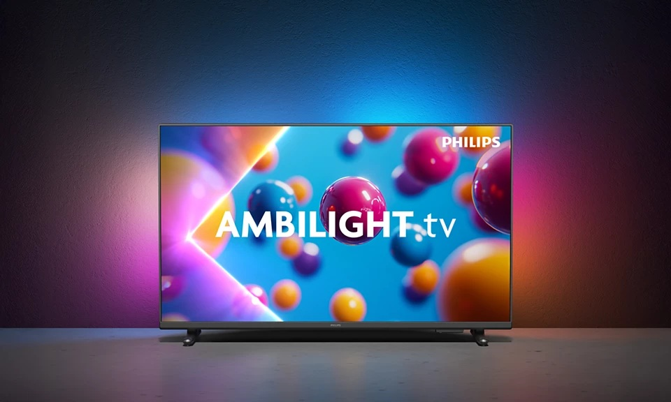 Telewizor Philips Ambilight wyświetla kolorowe kule. Ekran pokazuje napis 'AMBILIGHT.tv' na rozmytym tle.