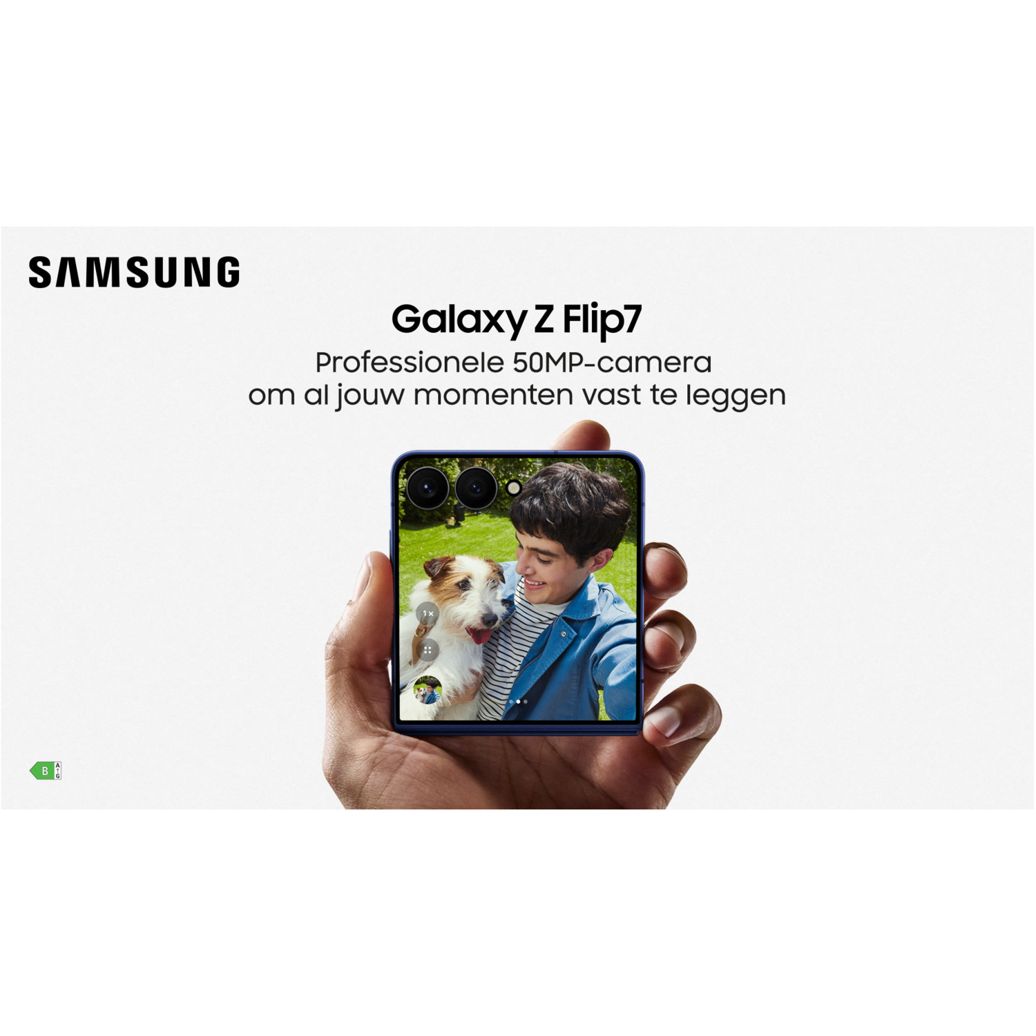 A person holds a Samsung phone displaying a man and dog. The phone is held in front of a white background. Samsung logo is visible.