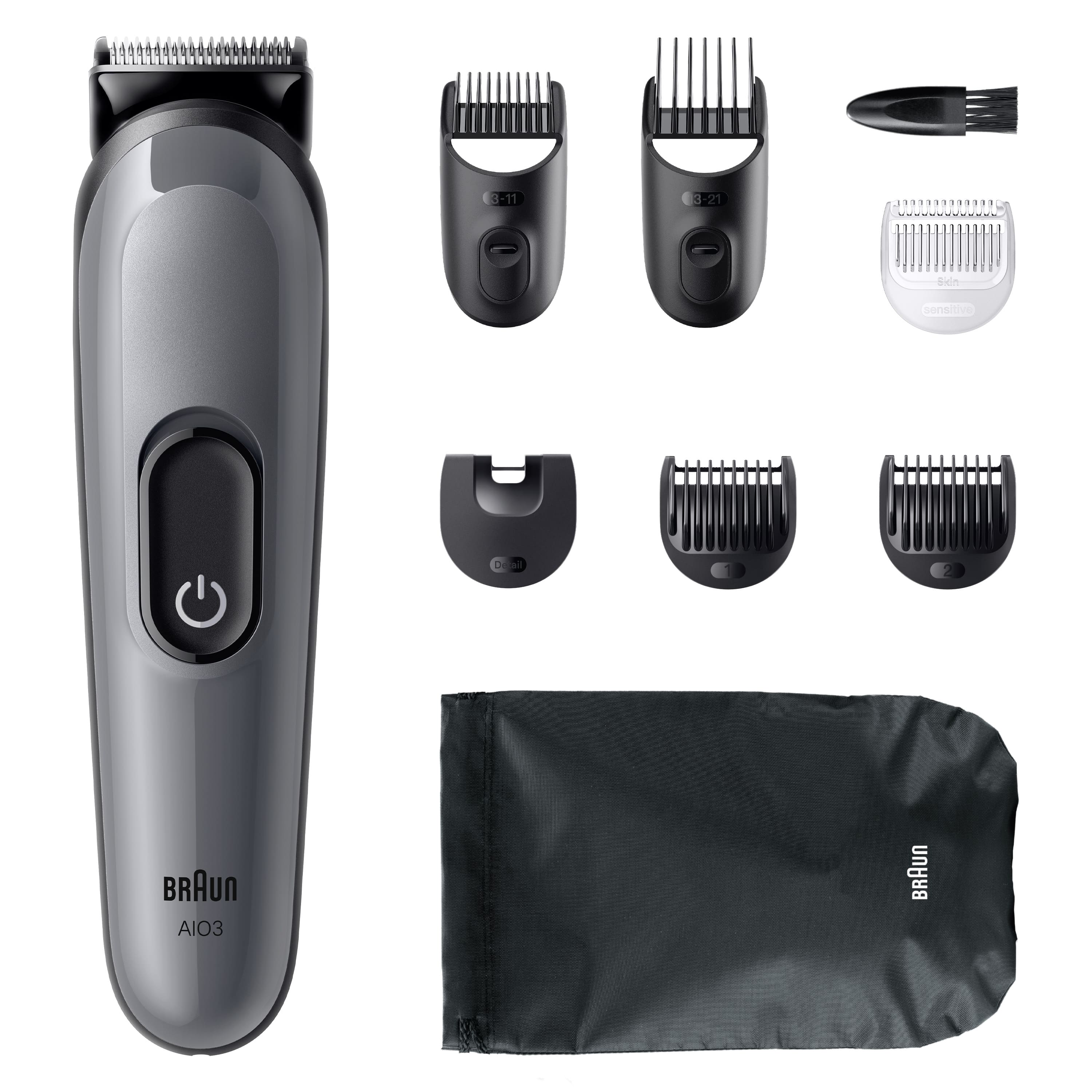 Gri Braun düzeltici ve aksesuarları. Kesme başlıkları, fırça ve kese içerir. Düzelticinin bir güç düğmesi vardır.