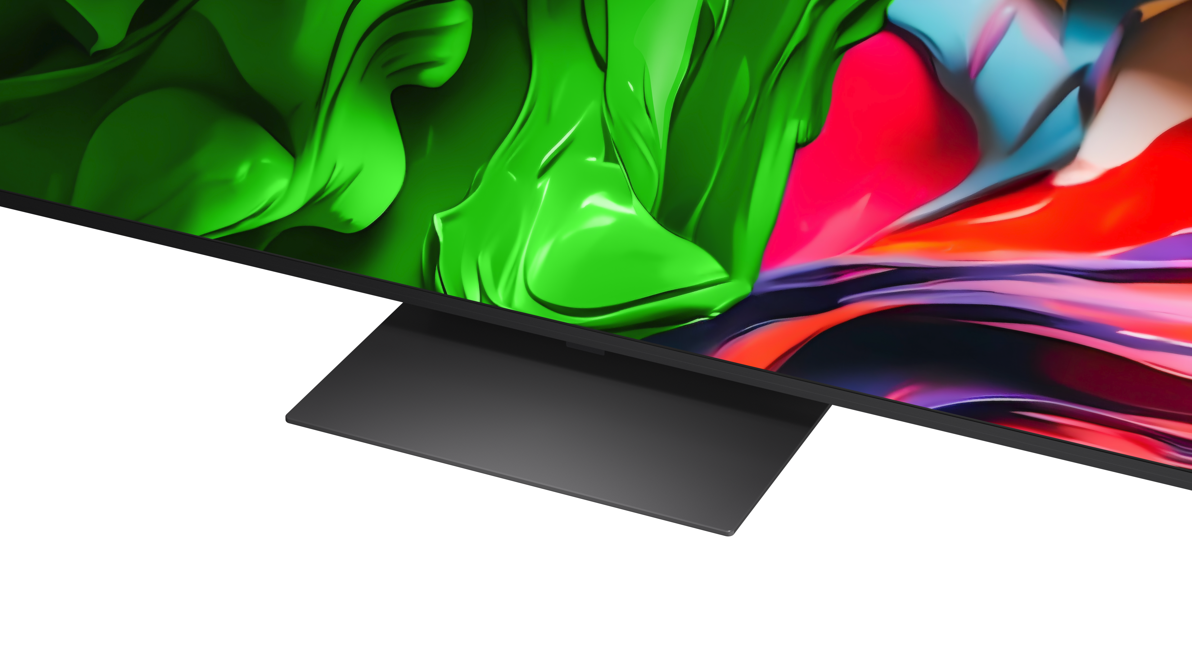 Zbliżenie monitora z czarną podstawą. Ekran wyświetla płynną sztukę abstrakcyjną w odcieniach zieleni, czerwieni i błękitu.