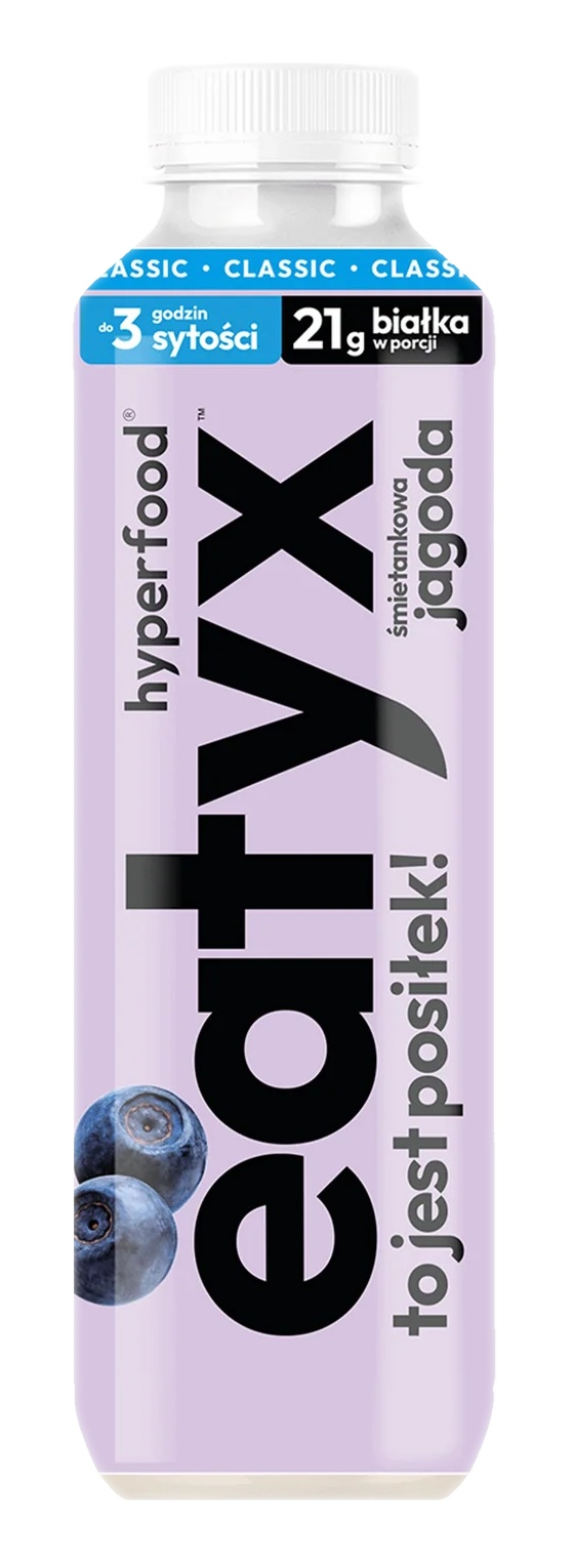 Butelka napoju proteinowego z jagodami. Zawiera tekst: eatyx, śmietankowa jagoda i 21g białka. Biała zakrętka i fioletowa etykieta.