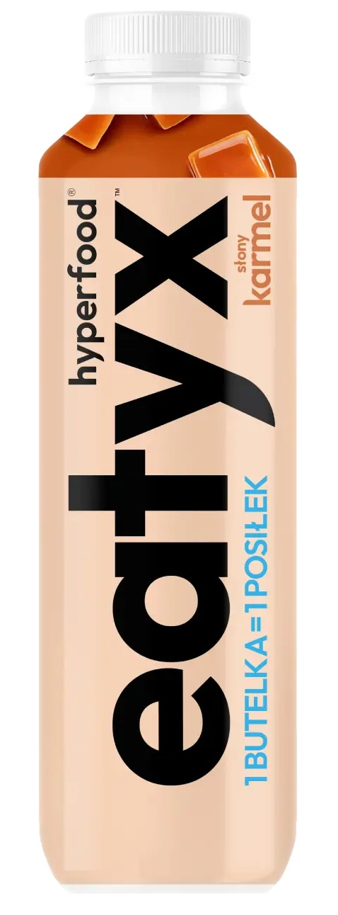 Butelka napoju o smaku słonego karmelu 'eat vyx'. Jest w kolorze brzoskwiniowym. Górna część butelki jest koloru karmelowego, a zakrętka biała.