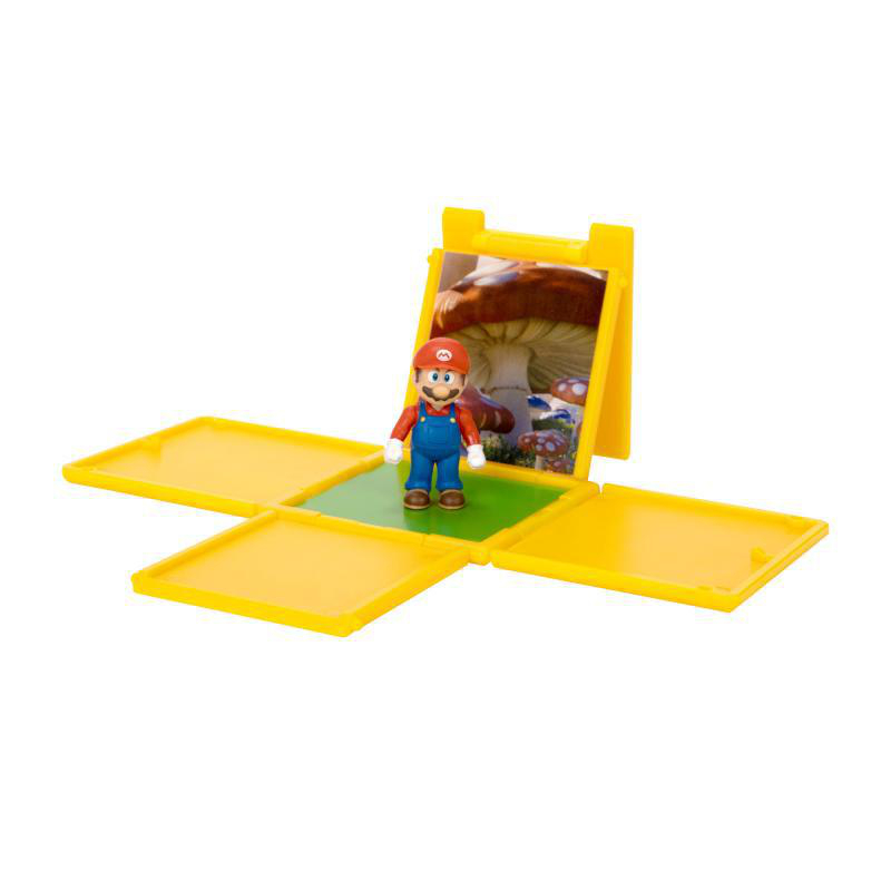 Eine Mario-Figur steht auf Grün in einer gelben Box. Der Hintergrund ist eine Pilzszene. Mehr gelbe Quadrate umgeben die Figur.