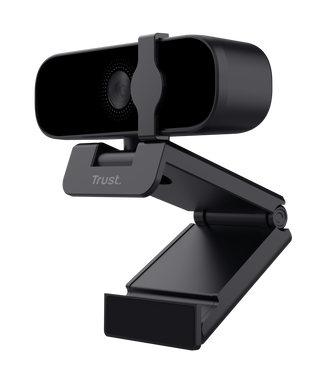 Czarna kamera internetowa ze stojakiem. Ma obiektyw, mikrofon i markę 'Trust'.