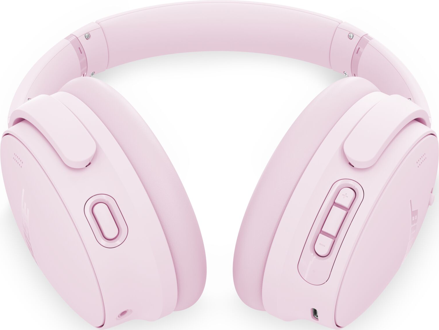 Casque sans fil rose avec écouteurs et bandeau. Le casque possède des boutons et une entrée microphone. Le fond est blanc.