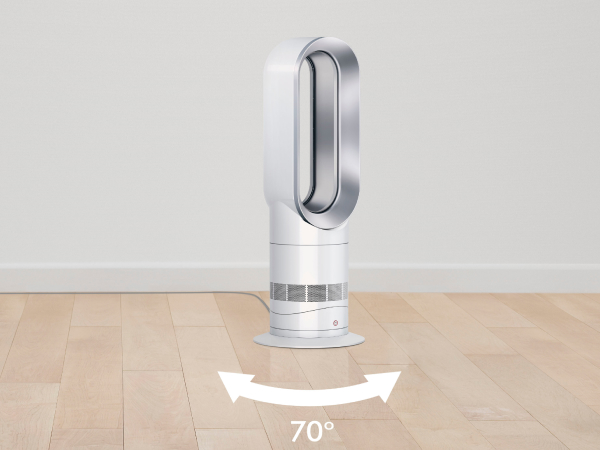 Un ventilador Dyson blanco y plateado se encuentra en un suelo de madera contra una pared blanca.
