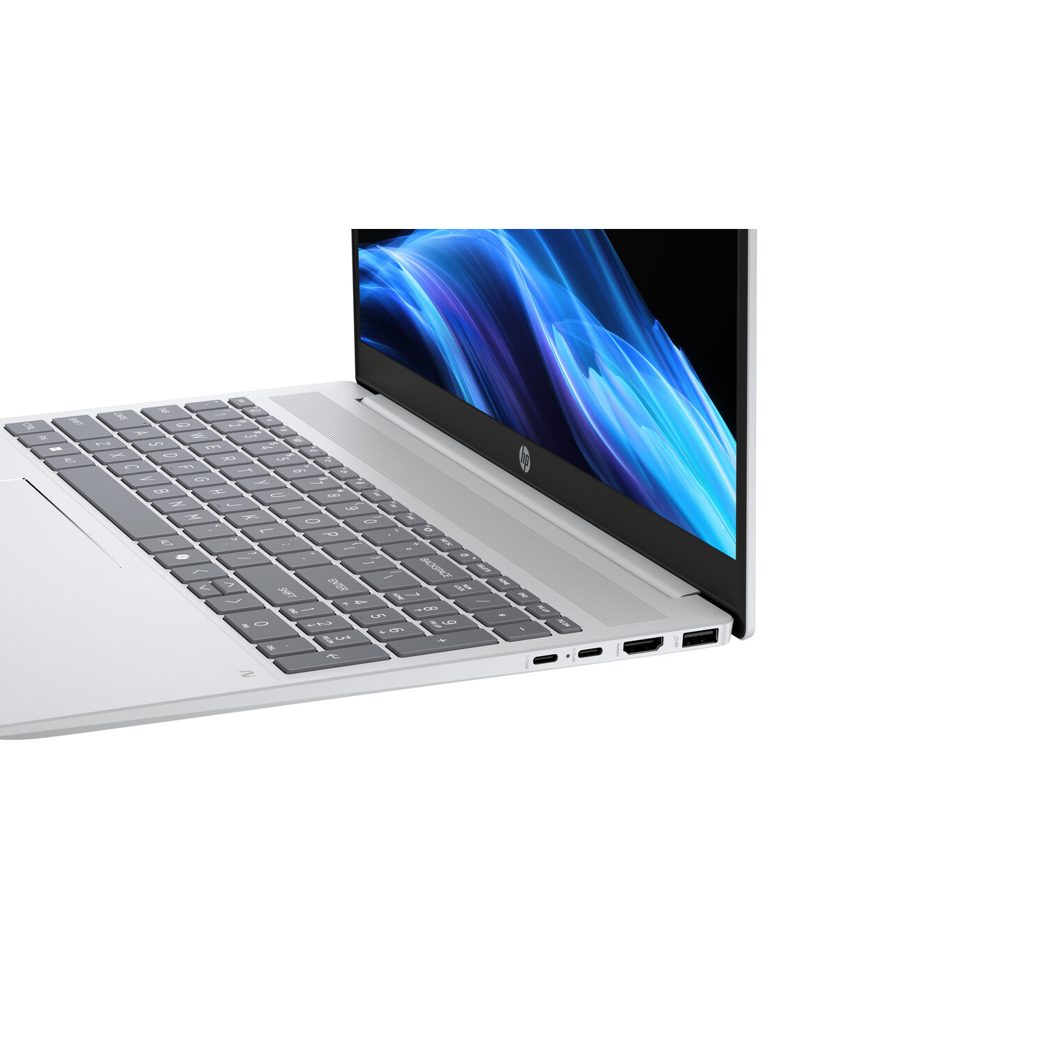 A silver laptop on a white background. The screen displays blue and white abstract art. The keyboard is visible.