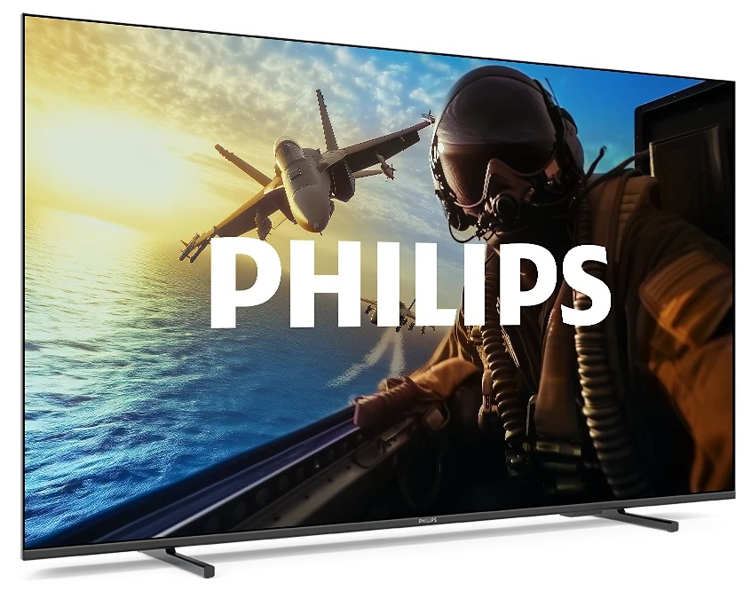 Telewizor Philips wyświetla myśliwiec w locie z pilotem. Niebo jest niebieskie i pomarańczowe, widać morze.