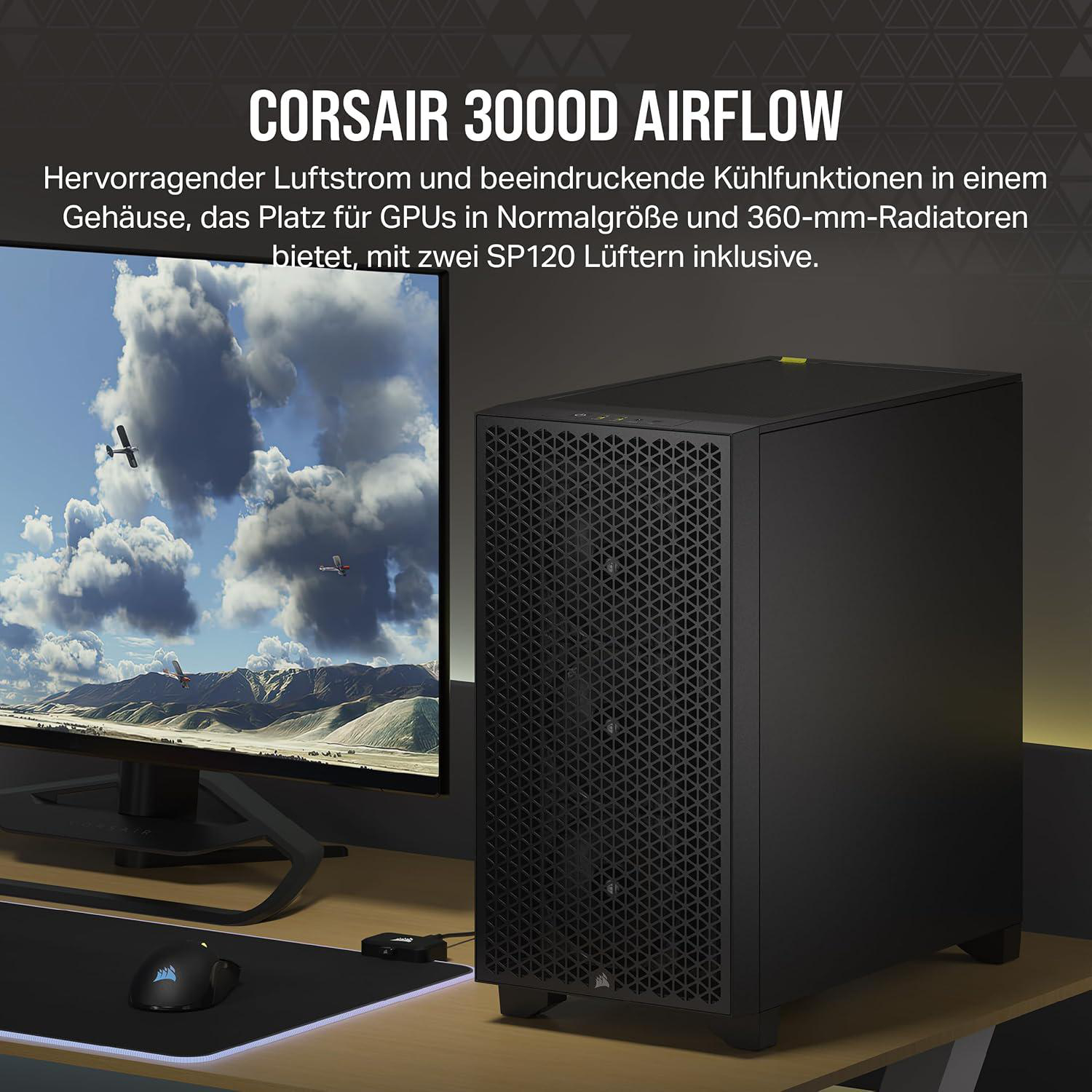 Schwarzes Computergehäuse mit Monitor, der Himmel mit Flugzeugen zeigt, Maus auf dem Schreibtisch.
