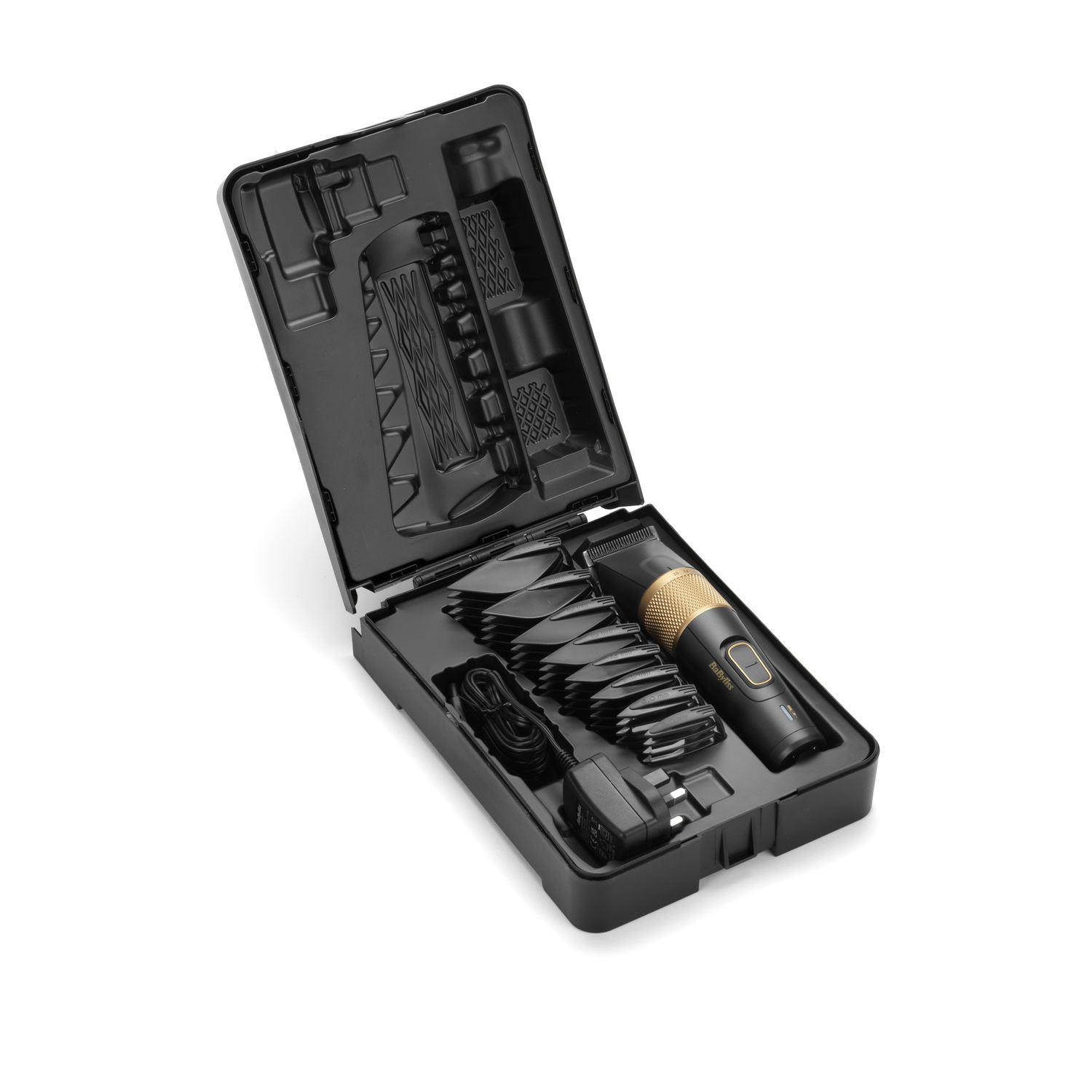 Black grooming kit opened, showing trimmer, attachments, charger. Gold and black trimmer. Black case on white background.