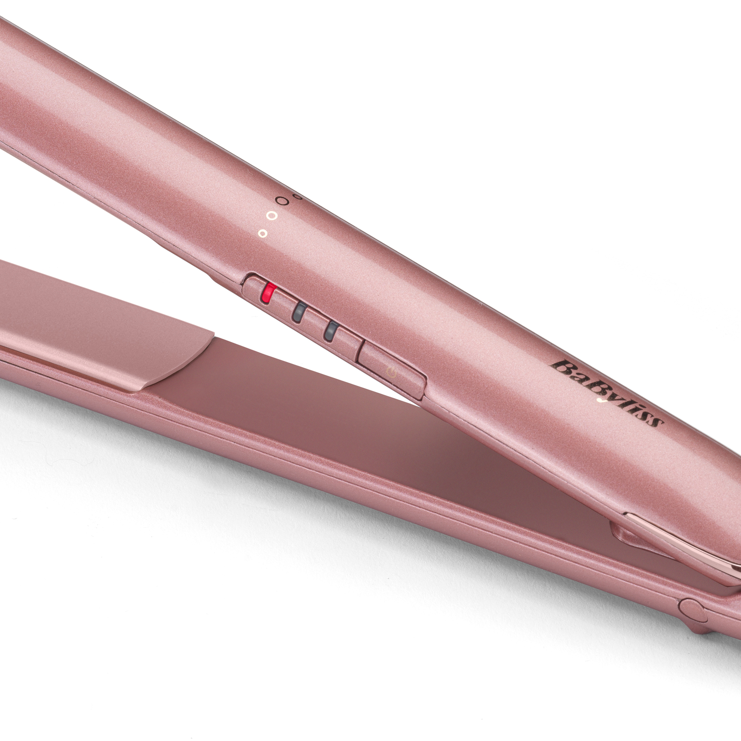 A rose gold Babyliss hair straightener is displayed. Red light is on. The brand name Babyliss is visible. The background is white.