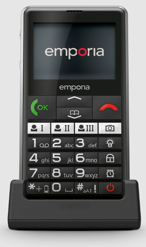 Ein schwarzes Emporia-Telefon auf einer Dockingstation. Es hat einen Bildschirm mit dem Logo und eine Tastatur mit großen Tasten und einer grünen Ruftaste.